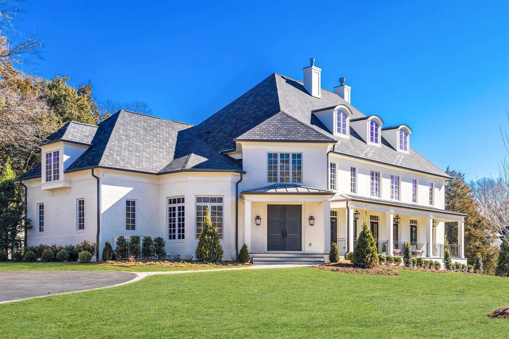 The exterior of a large white home.