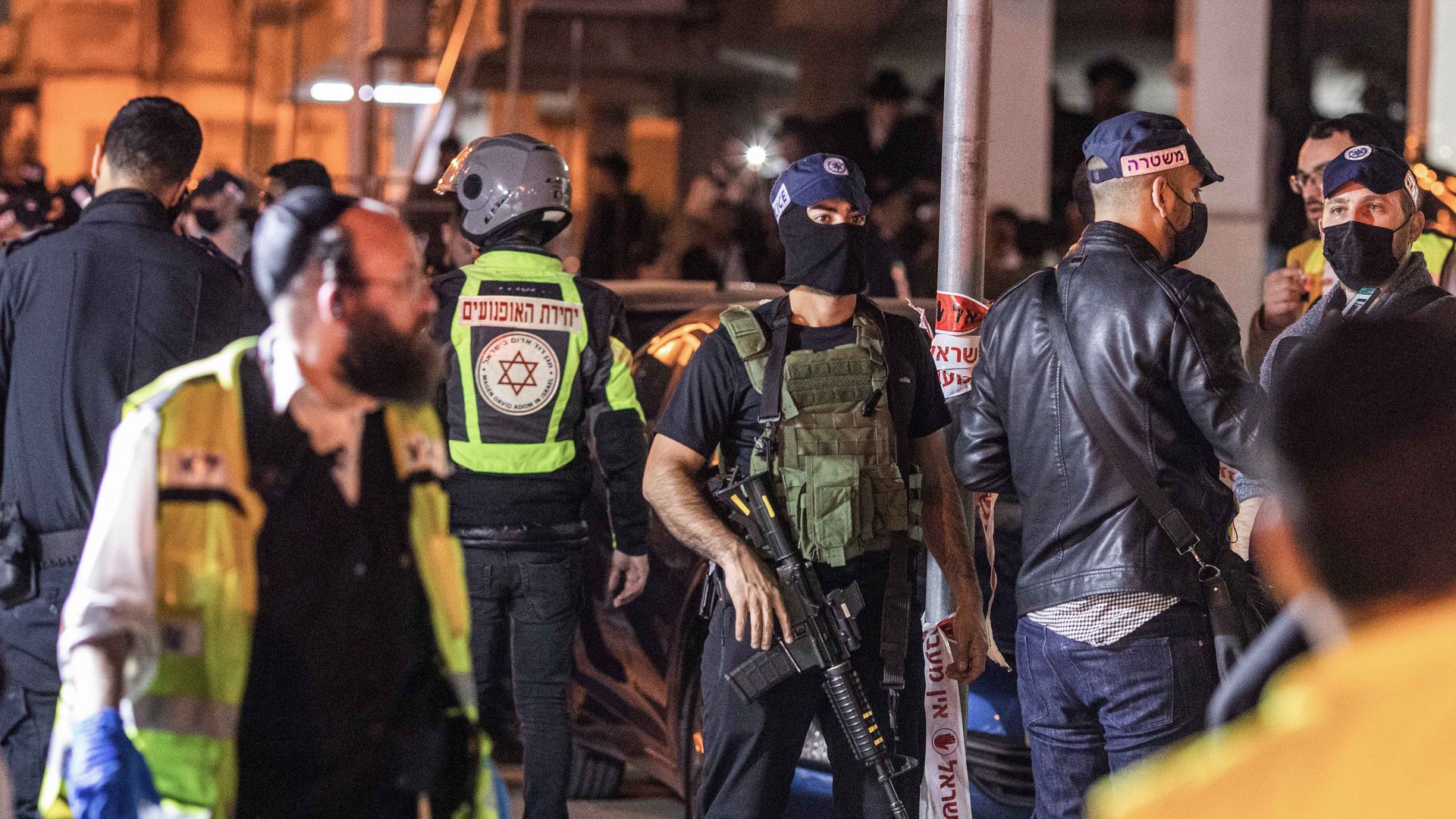 : Security forces stand at the scene following a shooting attack in Beni Brak, Israel.