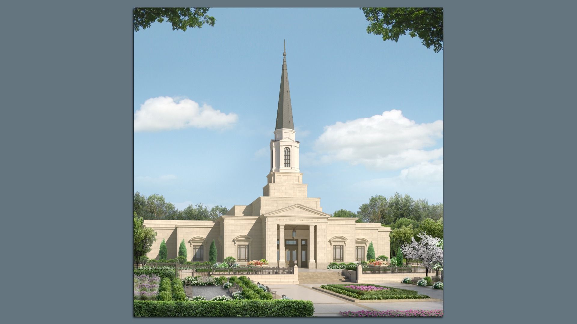 Beige stone temple with a tall, pointed gray steeple rising above a stepped facade. Front garden with hedges and flowers, blue sky with fluffy clouds behind, trees frame the scene.
