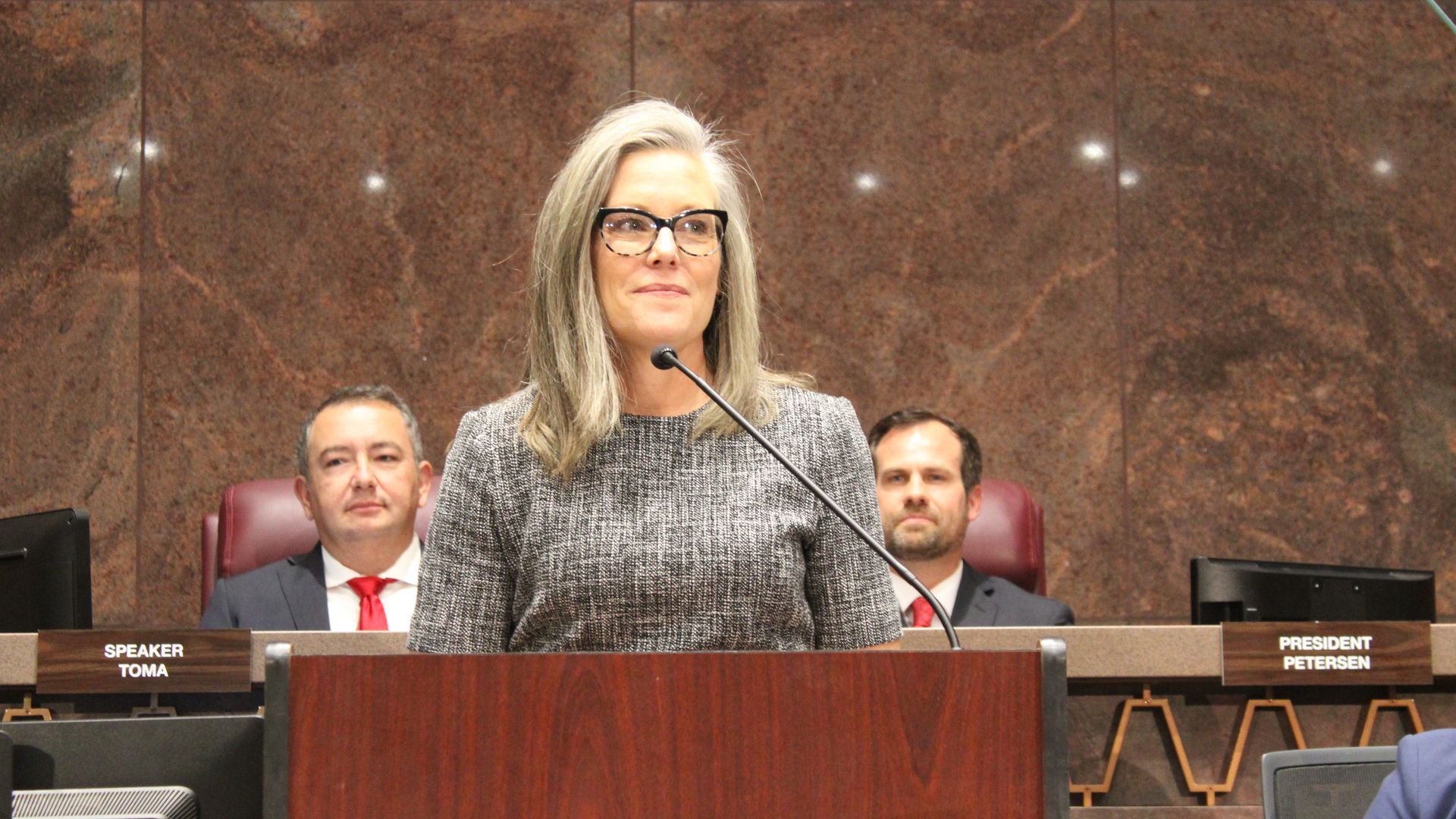 Governor Katie Hobbs smiles during her State of the State address