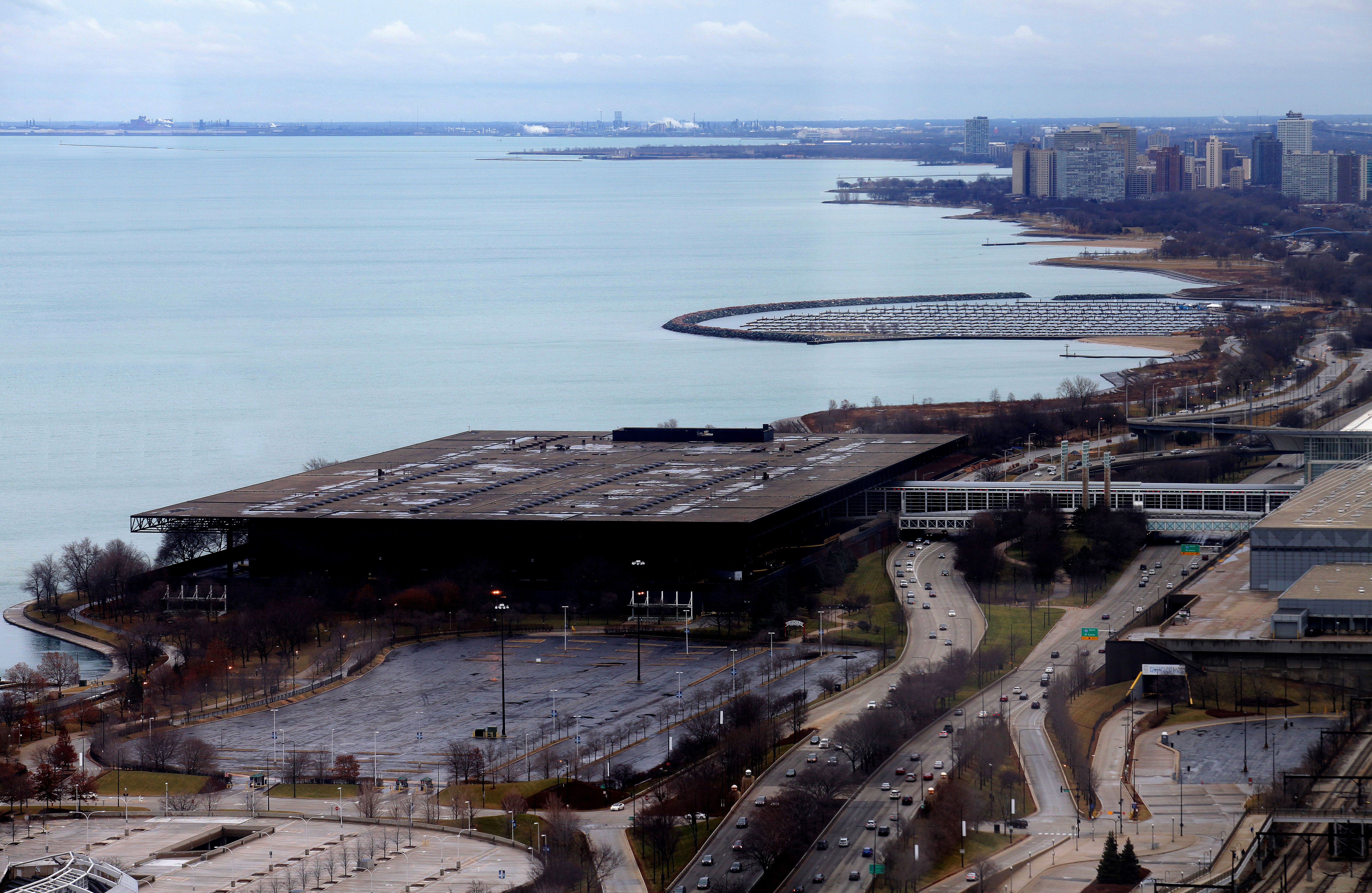 Aerial photo of the roof of a building next to a lake. 