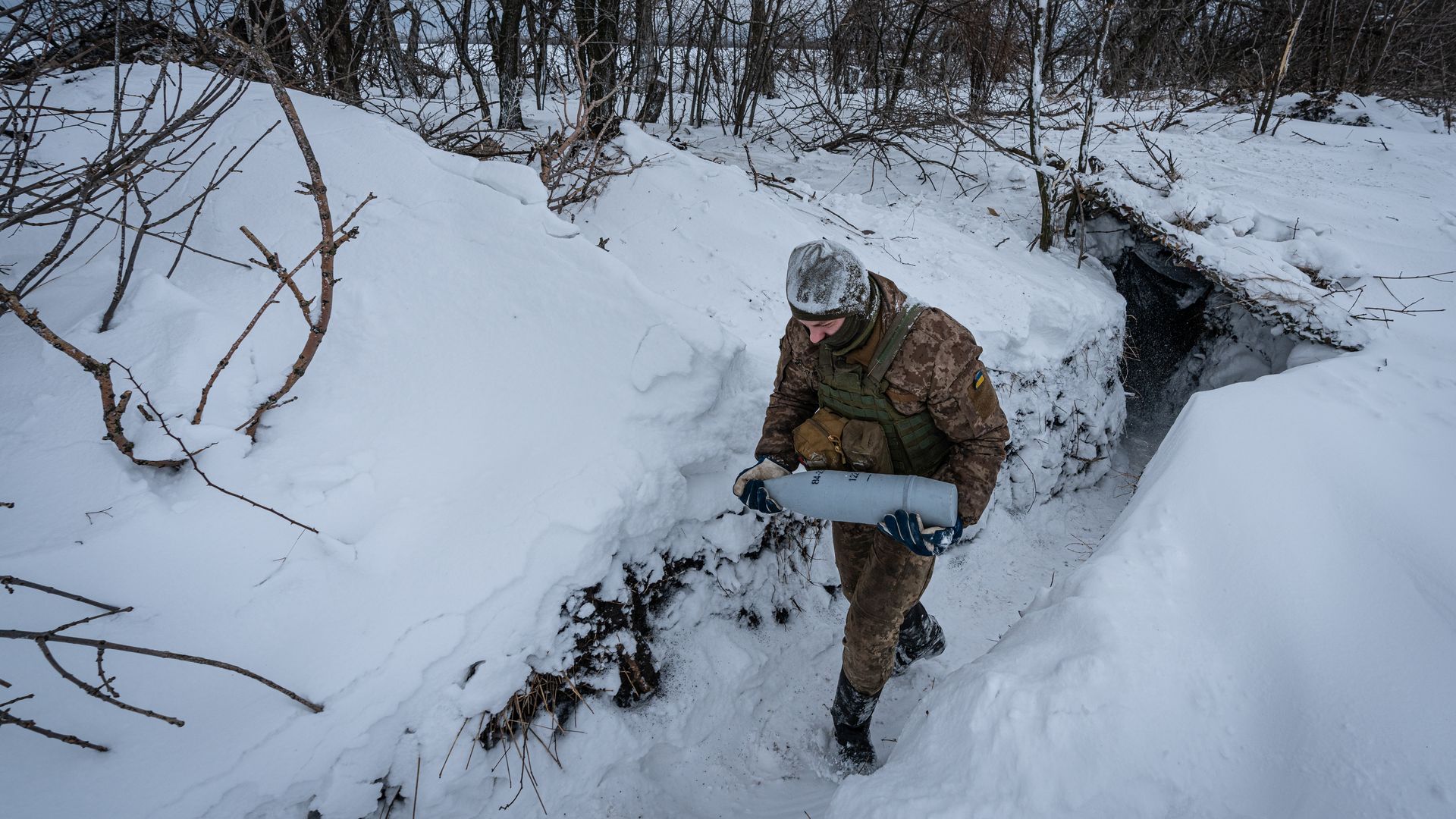 A Ukrainian solider carries a munition.