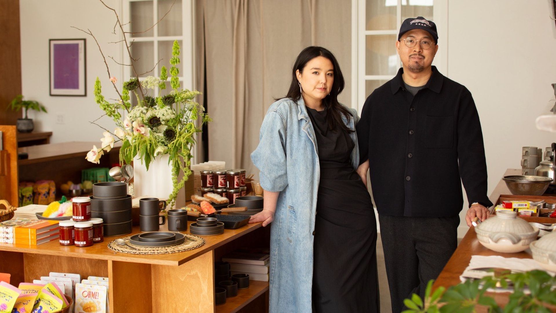 Tori and Nam standing in their store