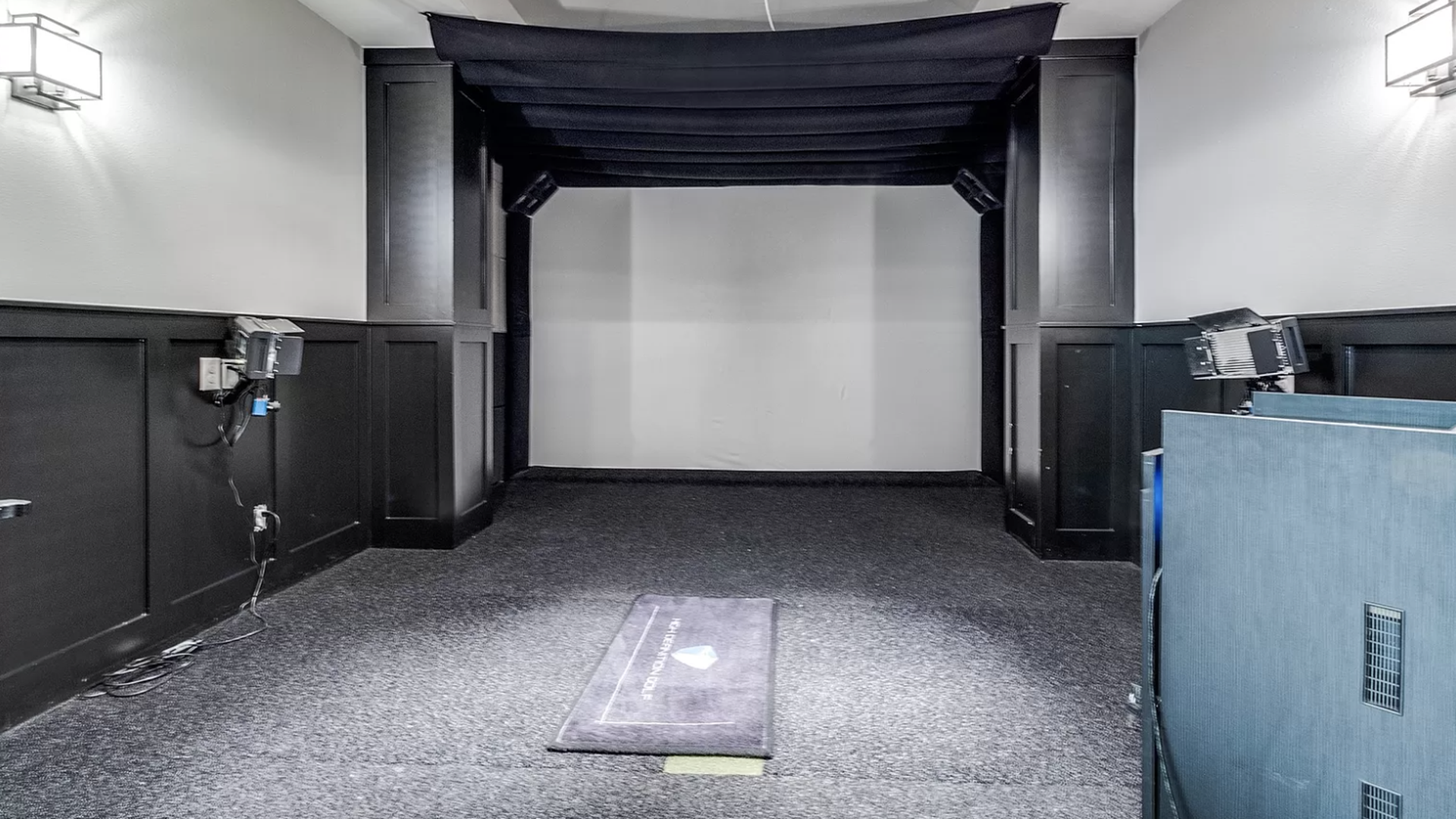 A golf simulator set up inside a home media room