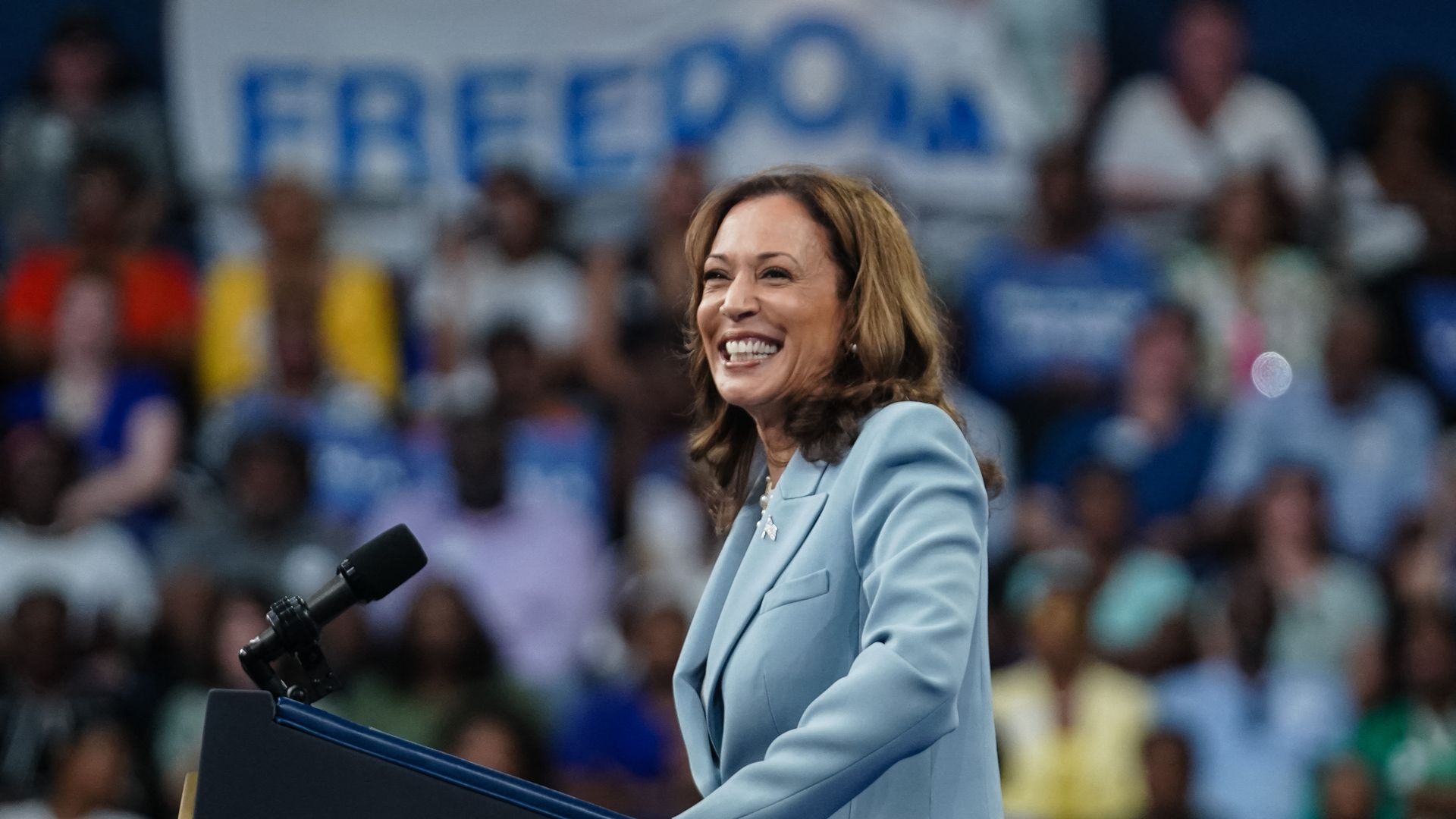 Kamala Harris smiling at podium during Atlanta rally