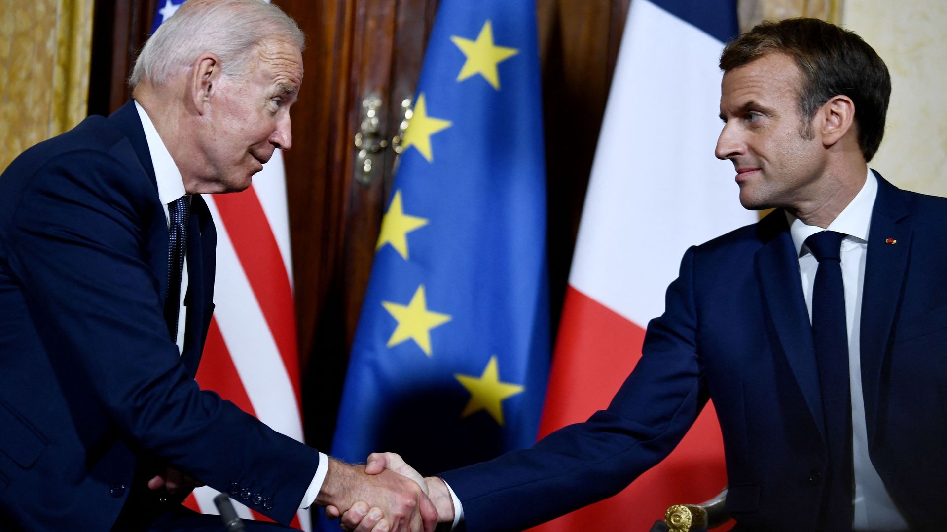 Picture of Biden and Macron shaking hands