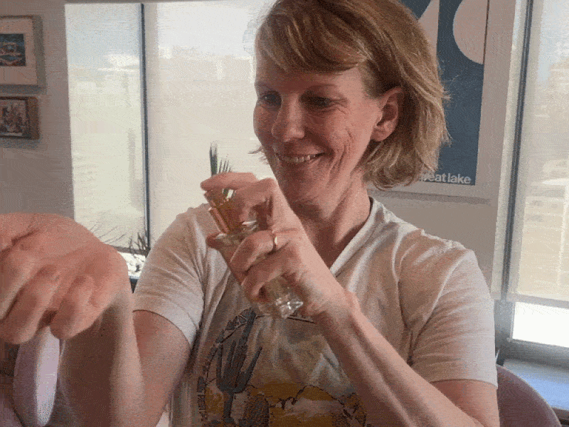 Gif of Carrie Shepherd spraying perfume on wrist, shaking wrist and smelling
