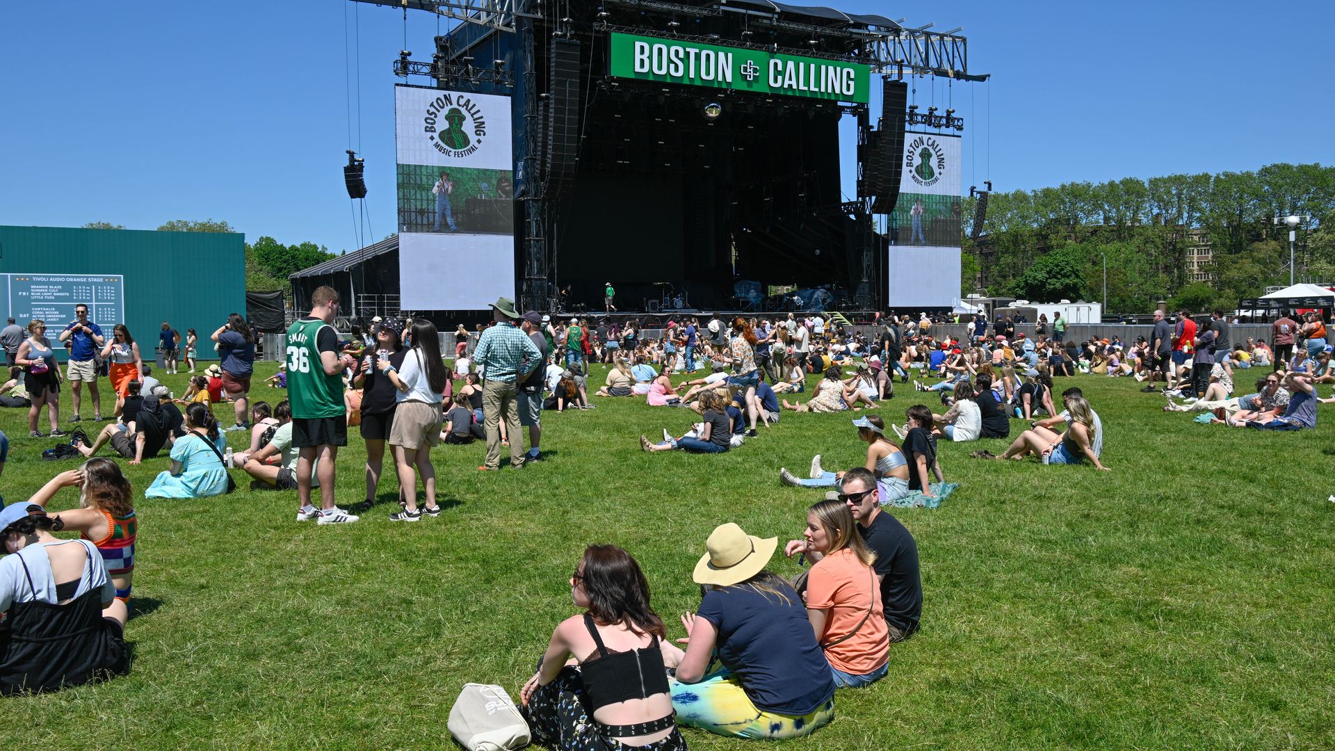 A large crowd gathers in front of an outdoor stage at the Boston Calling Music Festival.