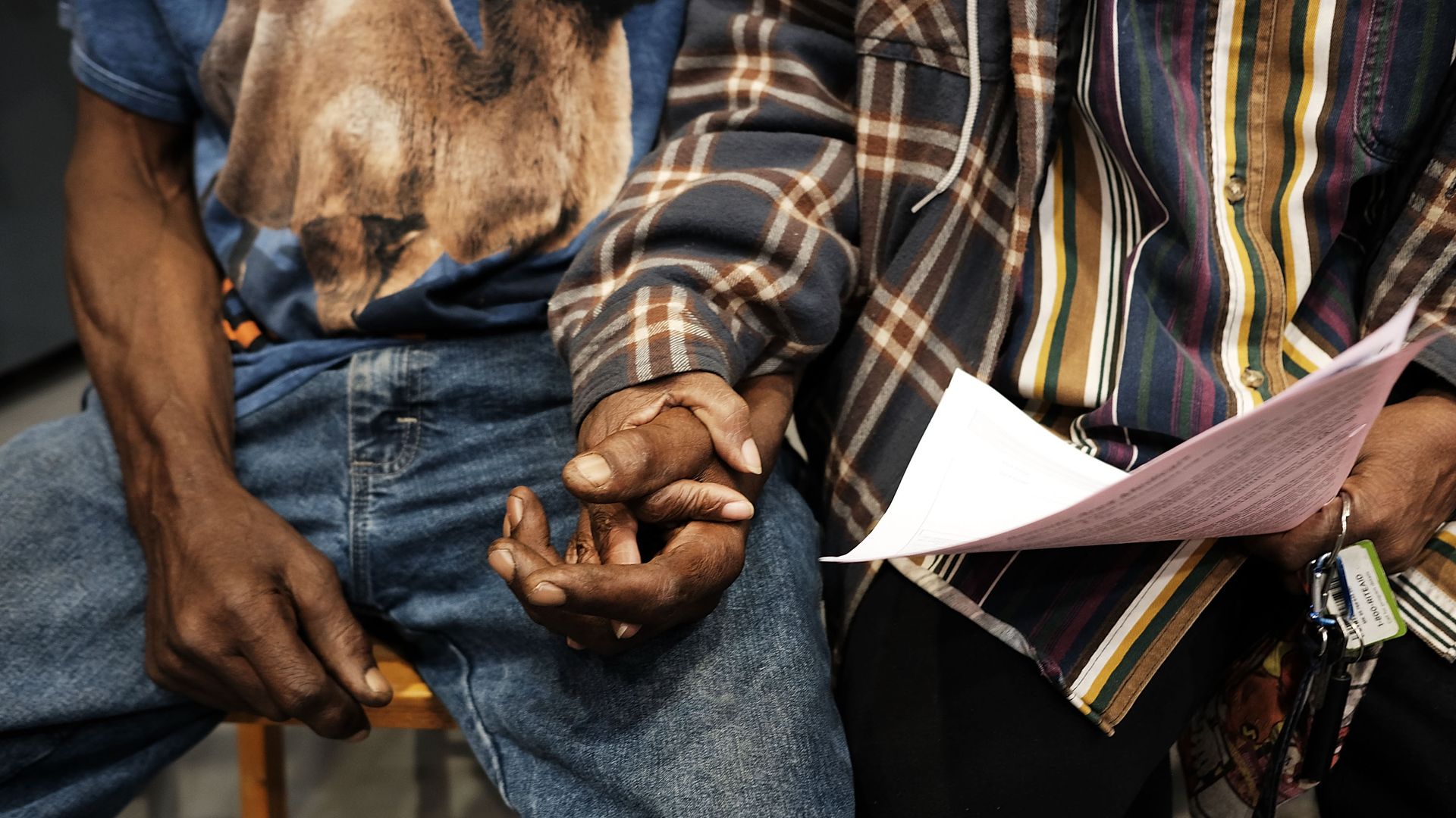 Photo of couple holding hands in waiting room before seeing a mobile doctor in rural New York