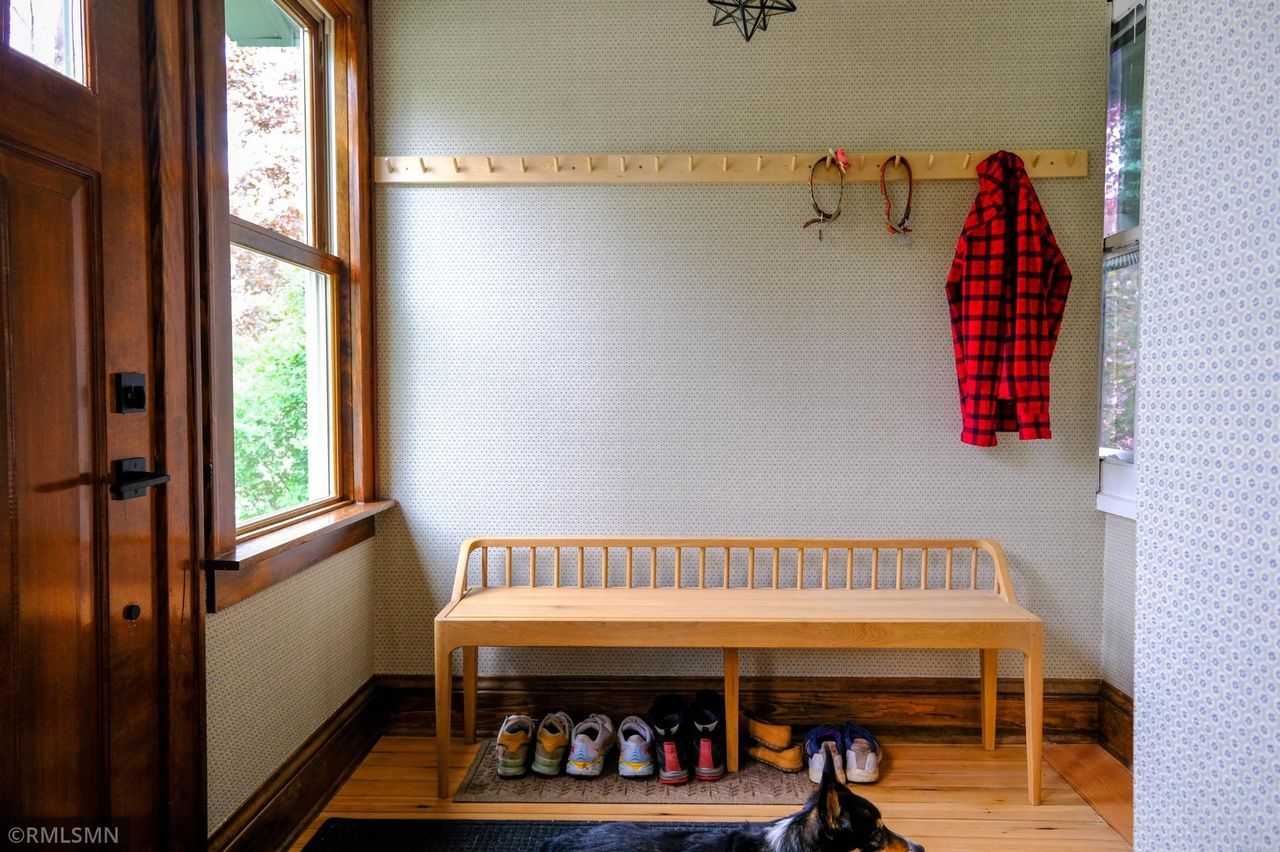 mudroom with restored wood and historic wallpaper