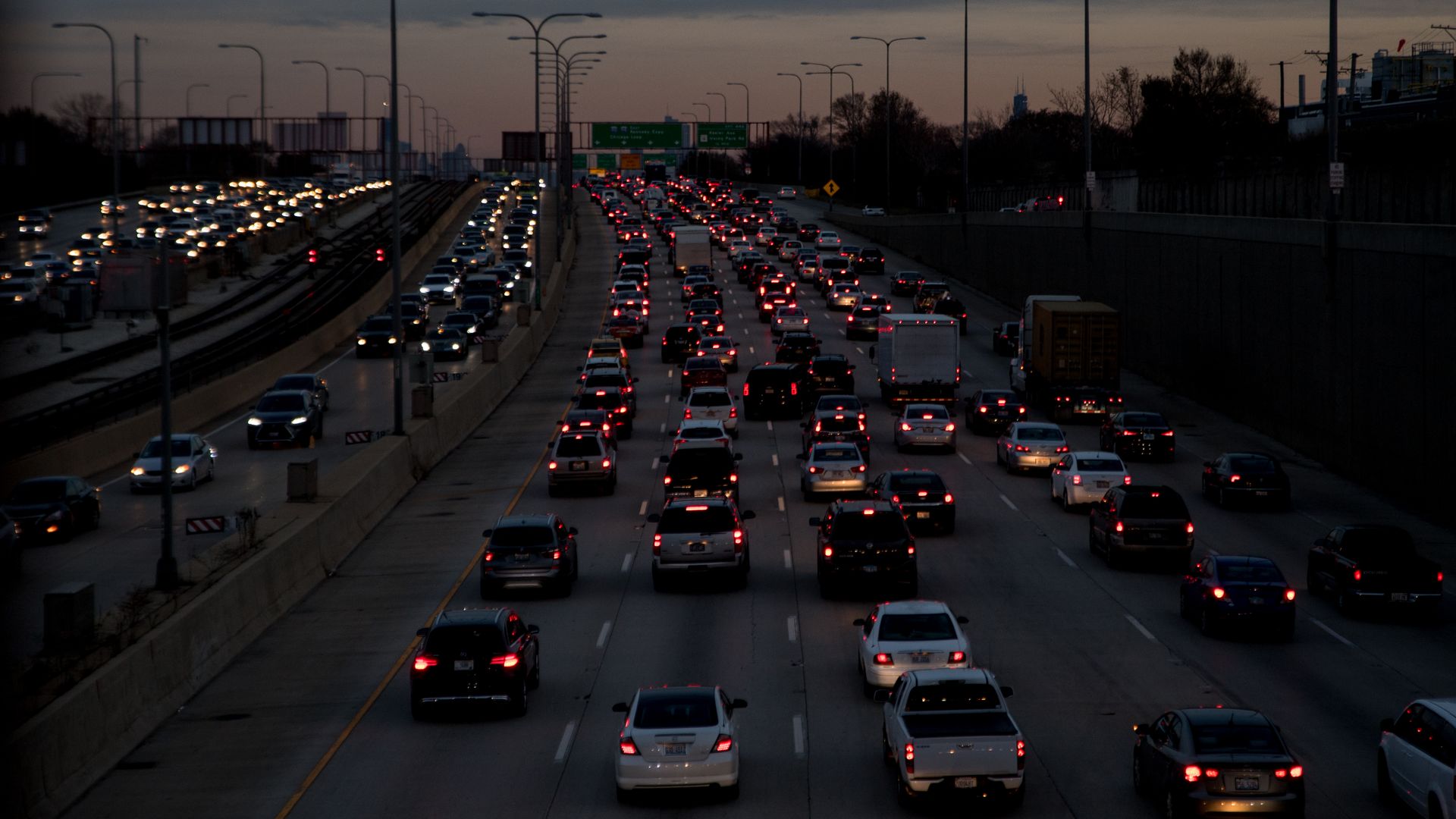 Masses of vehicles move slowly on the Montrose Ave overpass in Chicago at dusk 