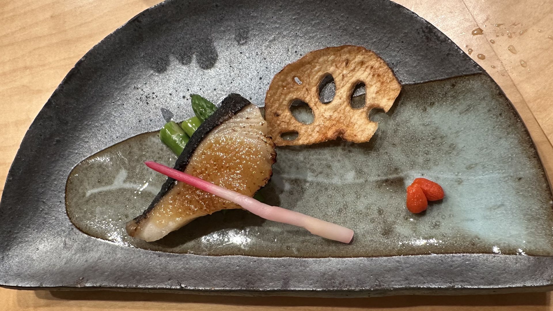 A plate with a piece of sushi on it.