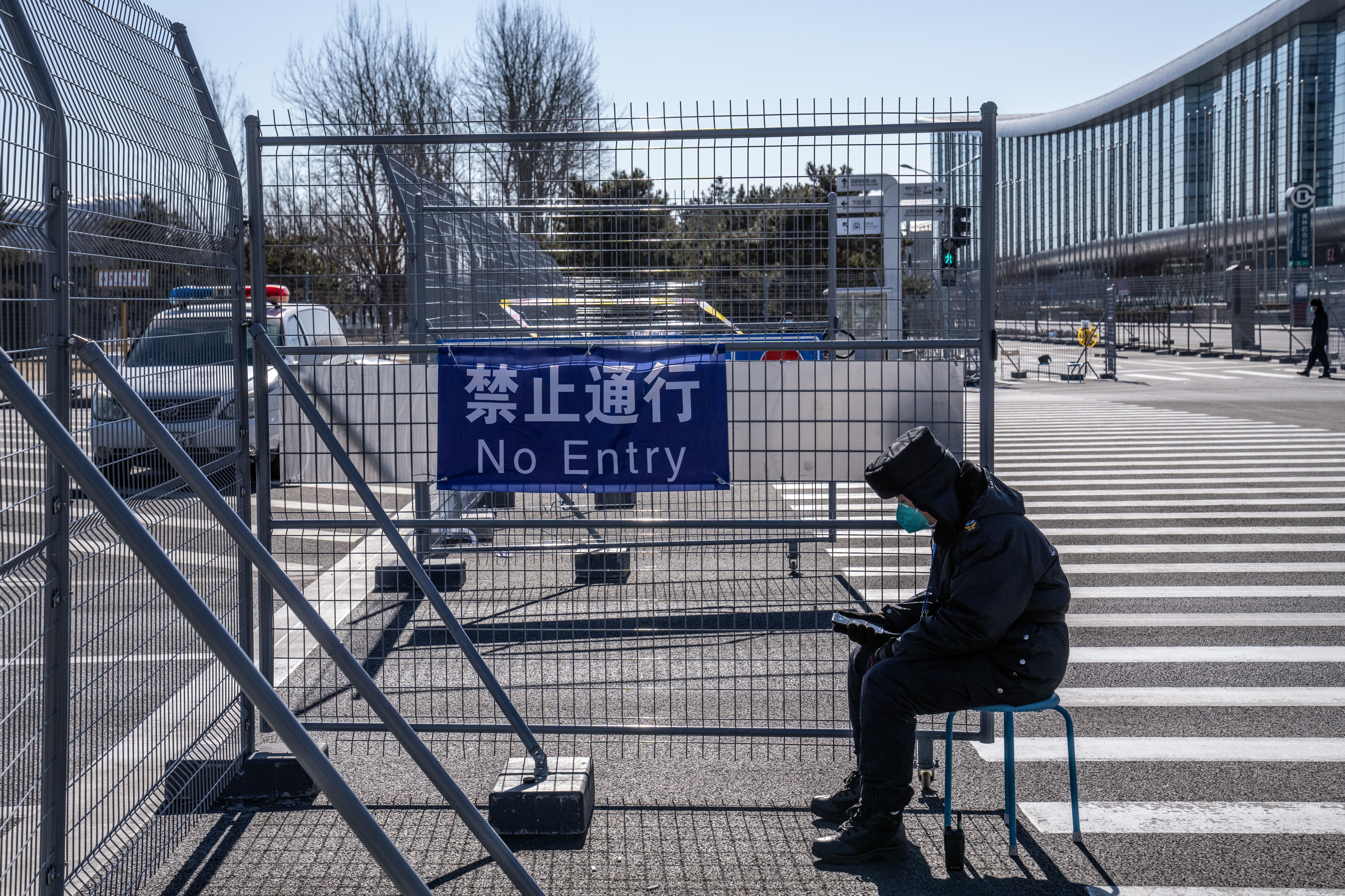 A security official mans a gate into the closed loop system at the Main Media Centre on February 2, 2022 in Beijing, China.