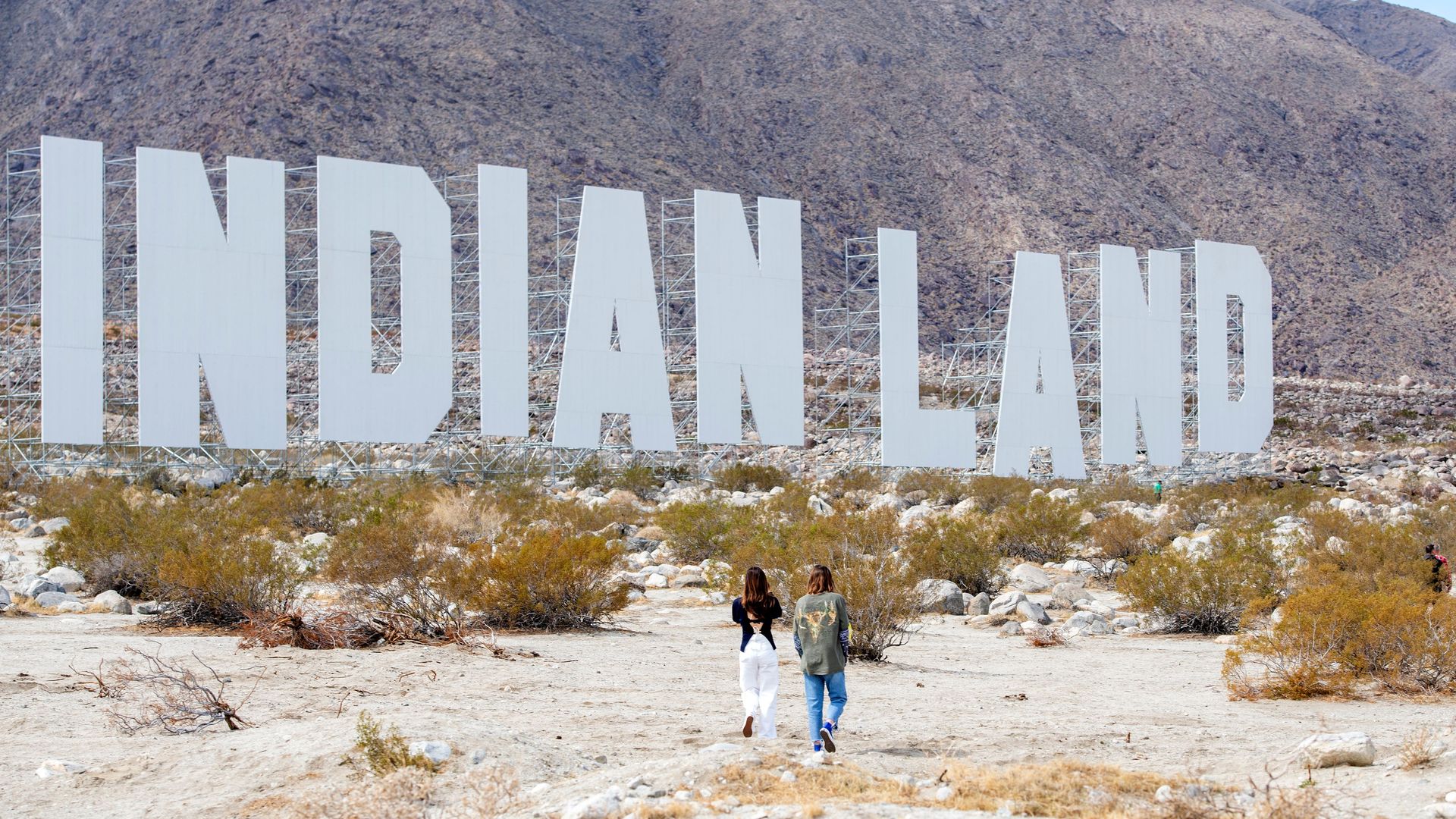 US artist Nicholas Galanin's piece, "Never Forget," on display in the Coachella Valley, the giant, white letters resemble the Hollywood sign, but reads "INDIAN LAND."
