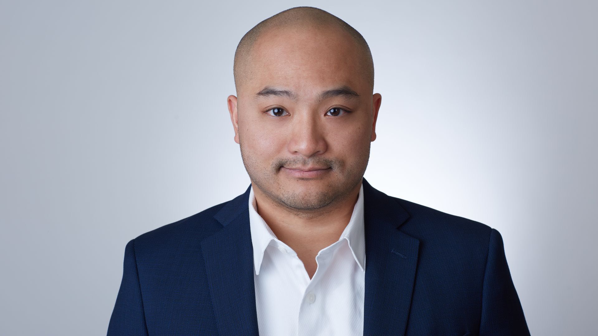Steve Tran looks at camera against a grey background.