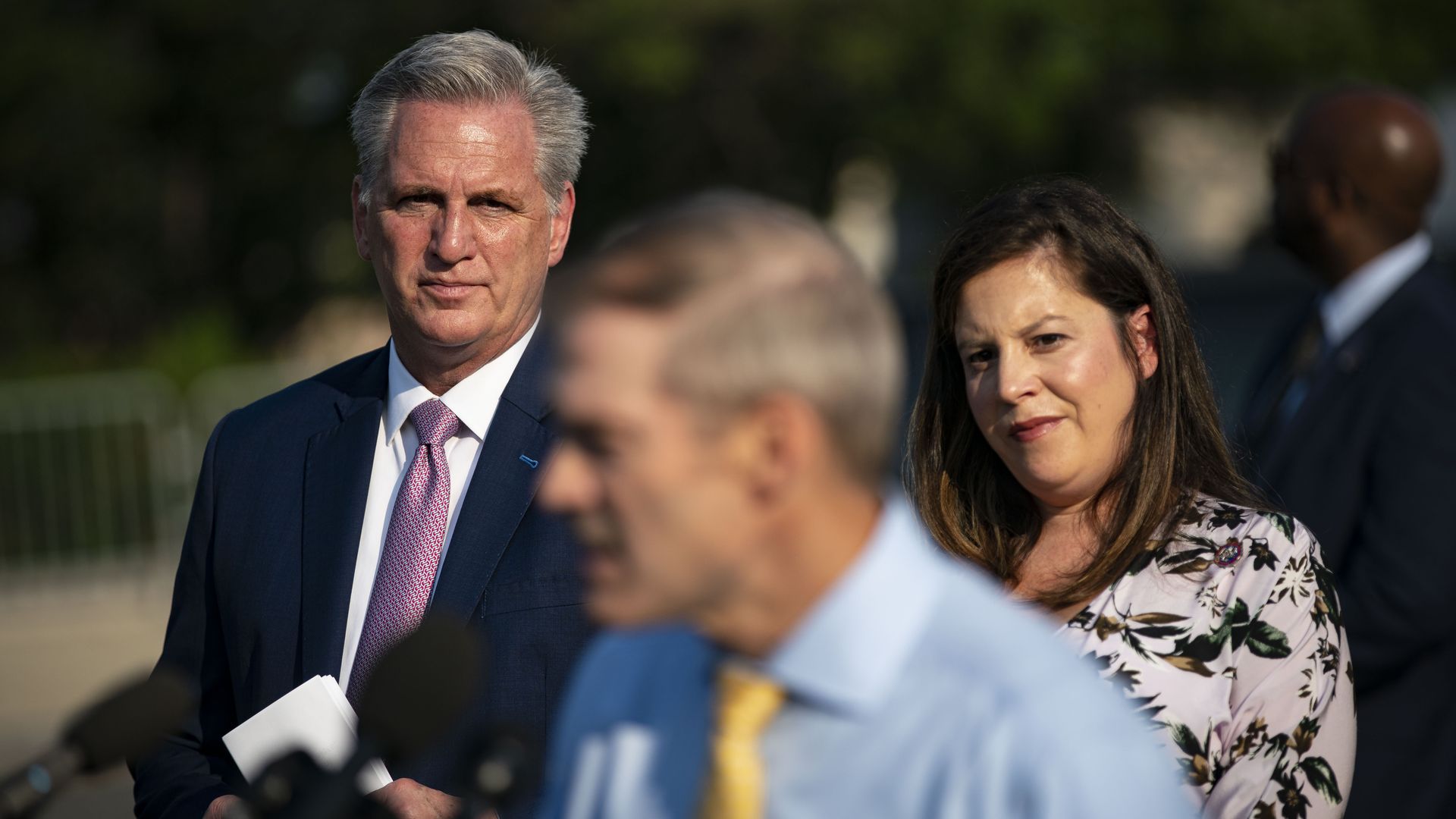 House Minority Leader Kevin McCarthy and Rep. Elise Stefanik are seen watching Rep. Jim Jordan speak before the first Jan. 6 select committee hearing.