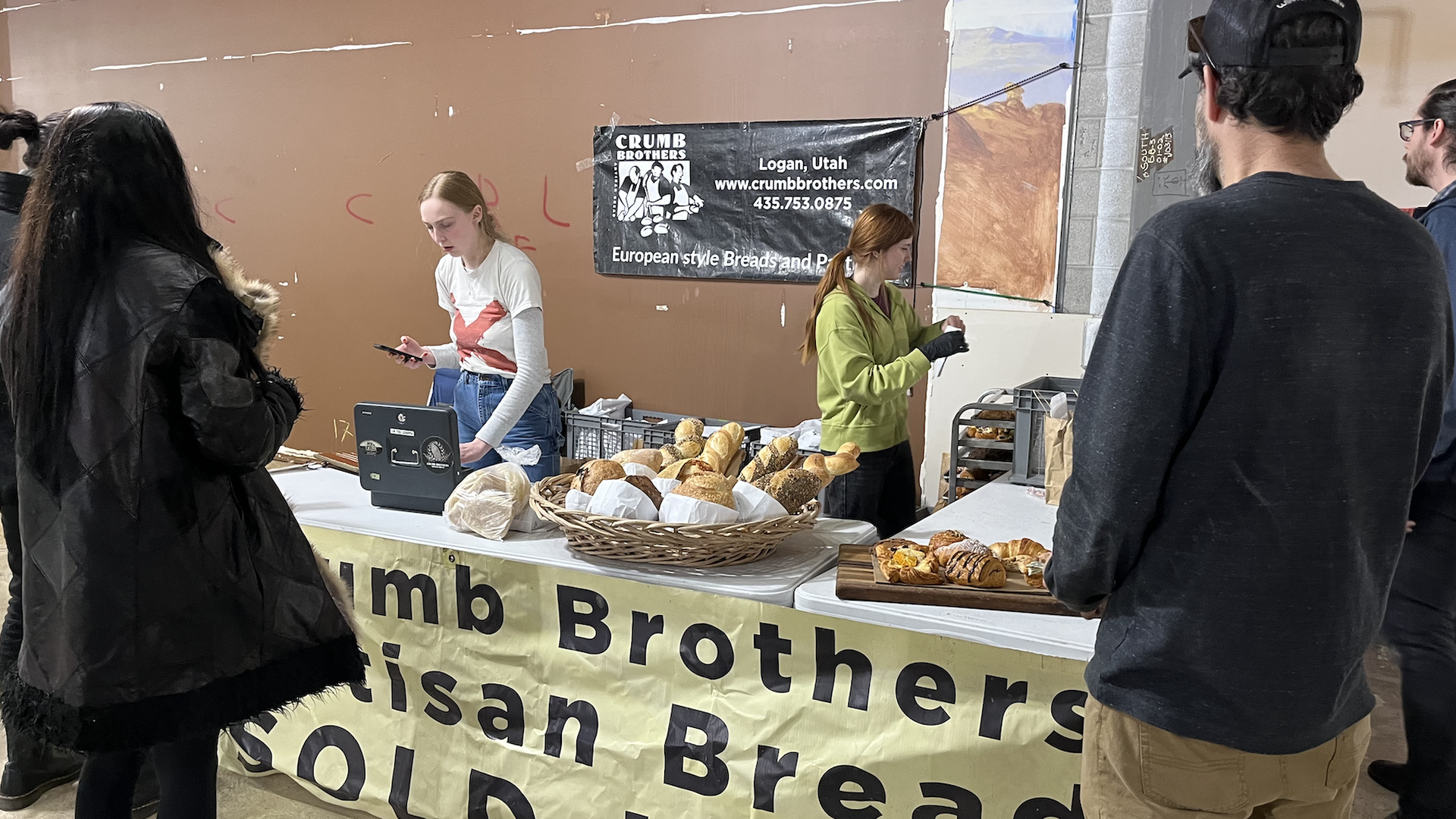 People selling fresh bread from a stand.