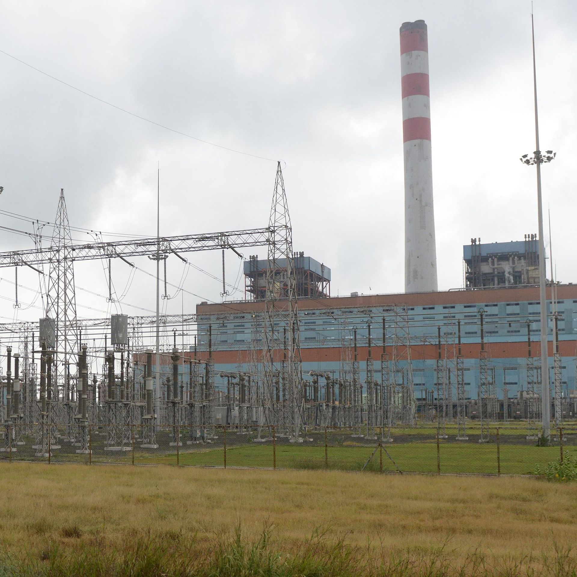 a coal-fired power plant behind an open field