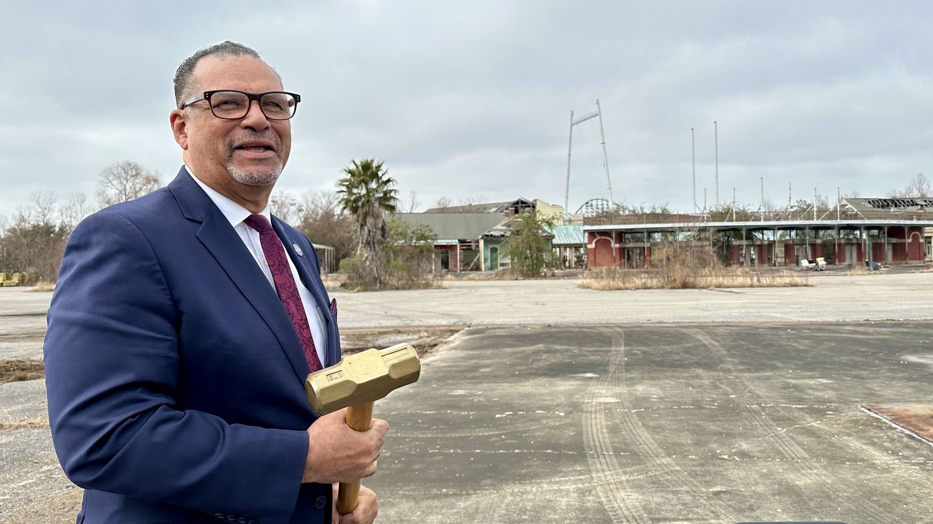 Photo shows Oliver Thomas with a golden hammer