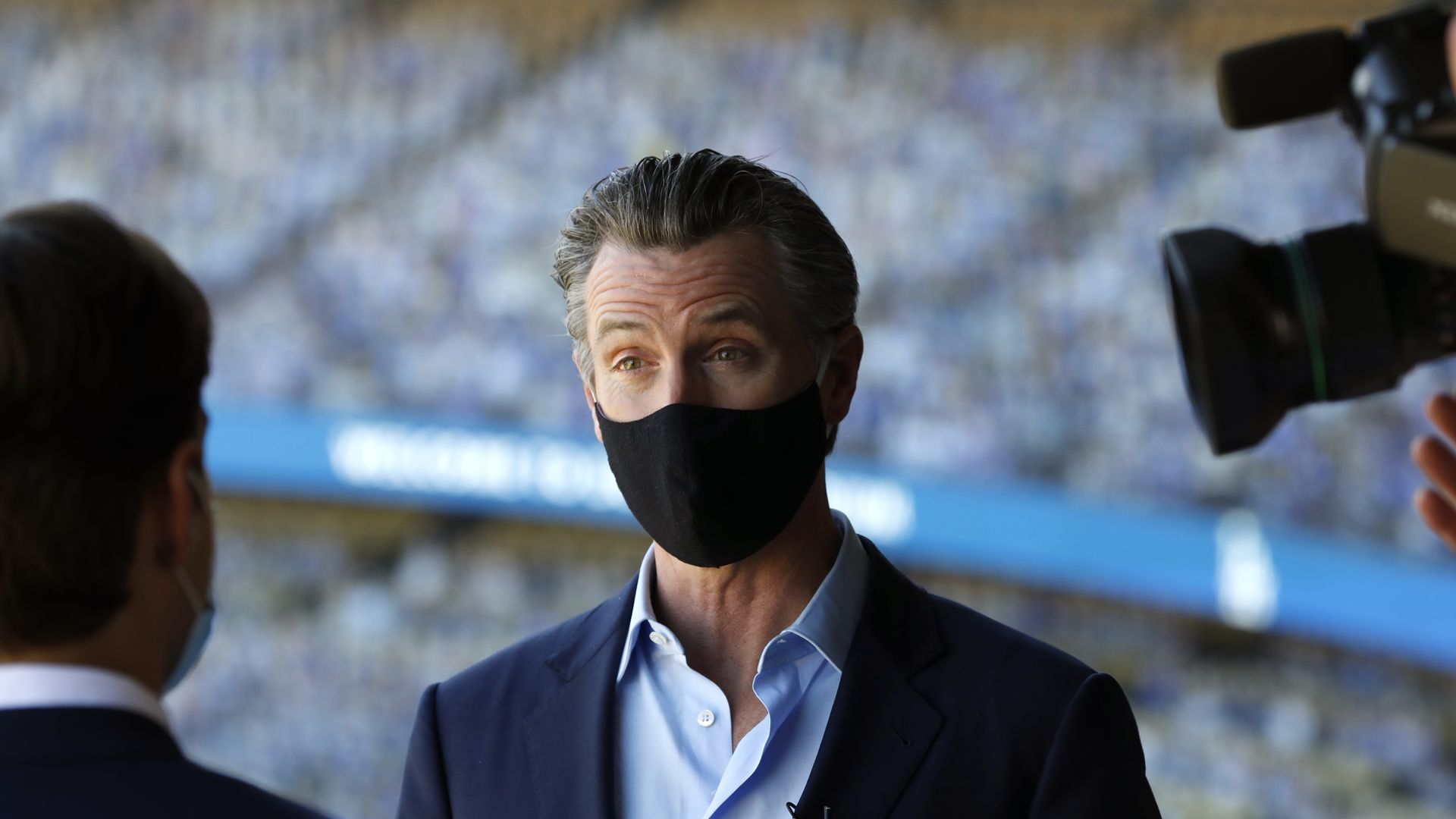 Gov. Gavin Newsom talks to the media after visiting Dodger Stadium on Oct. 30