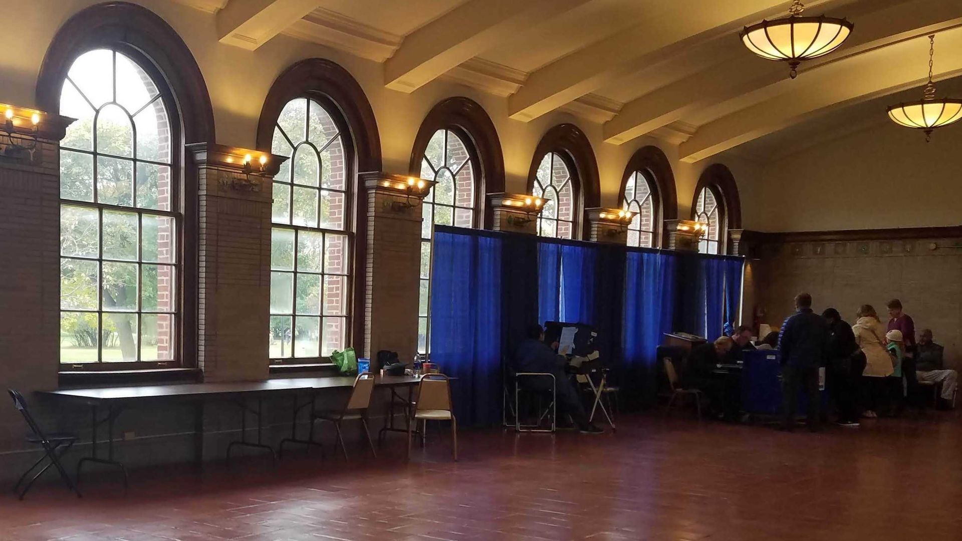 Photo of people voting at a polling place.