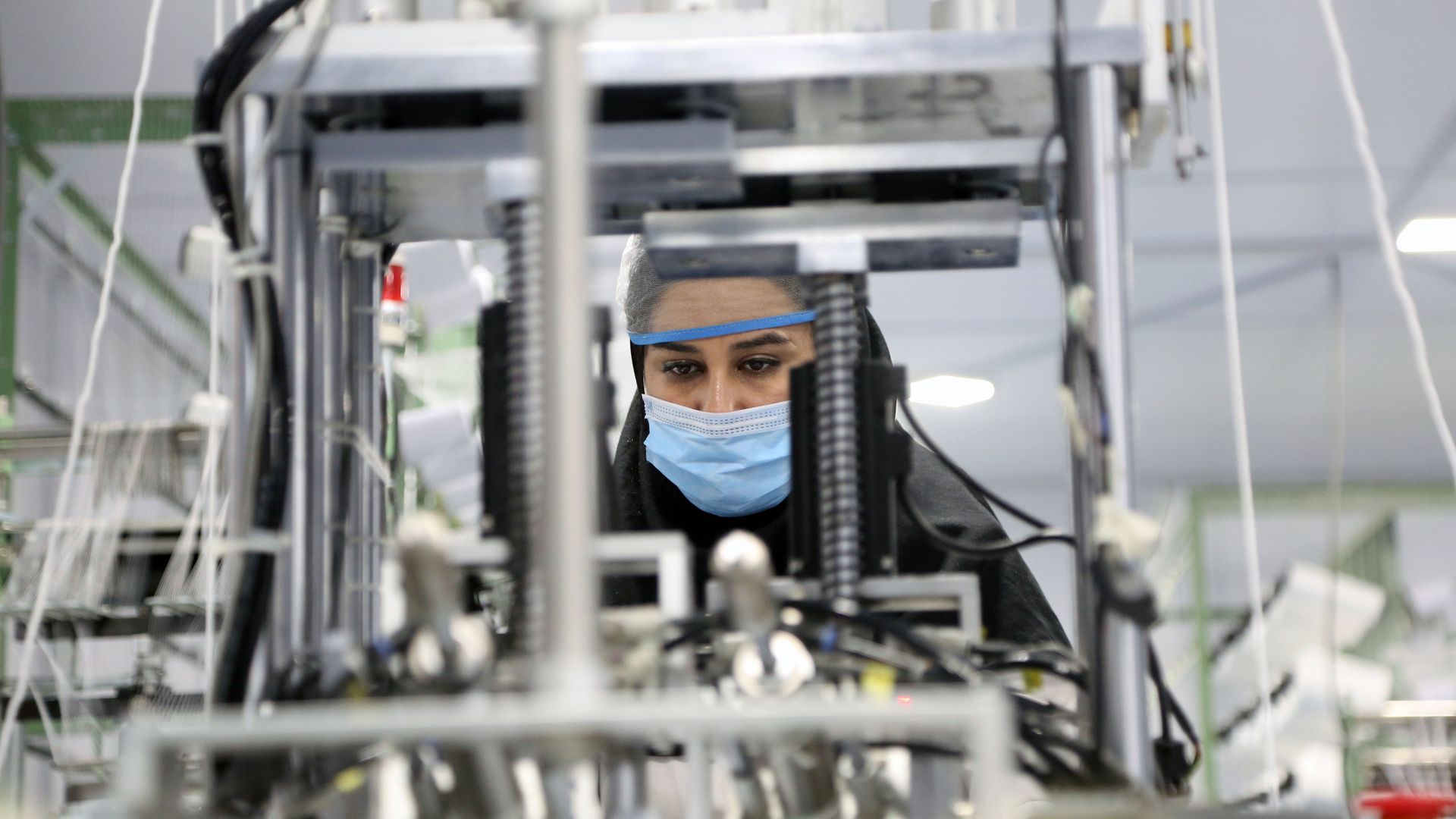 Iranian woman making masks