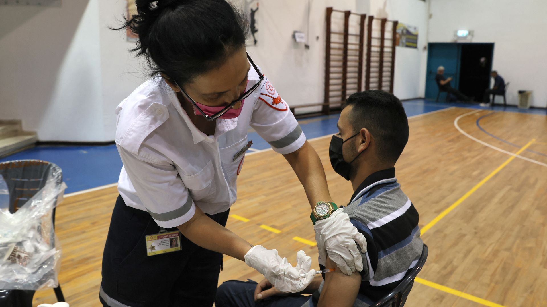 A paramedic administers the third shot of the Pfizer-BioNTech Covid-19 vaccine on Aug. 24 in Israel.