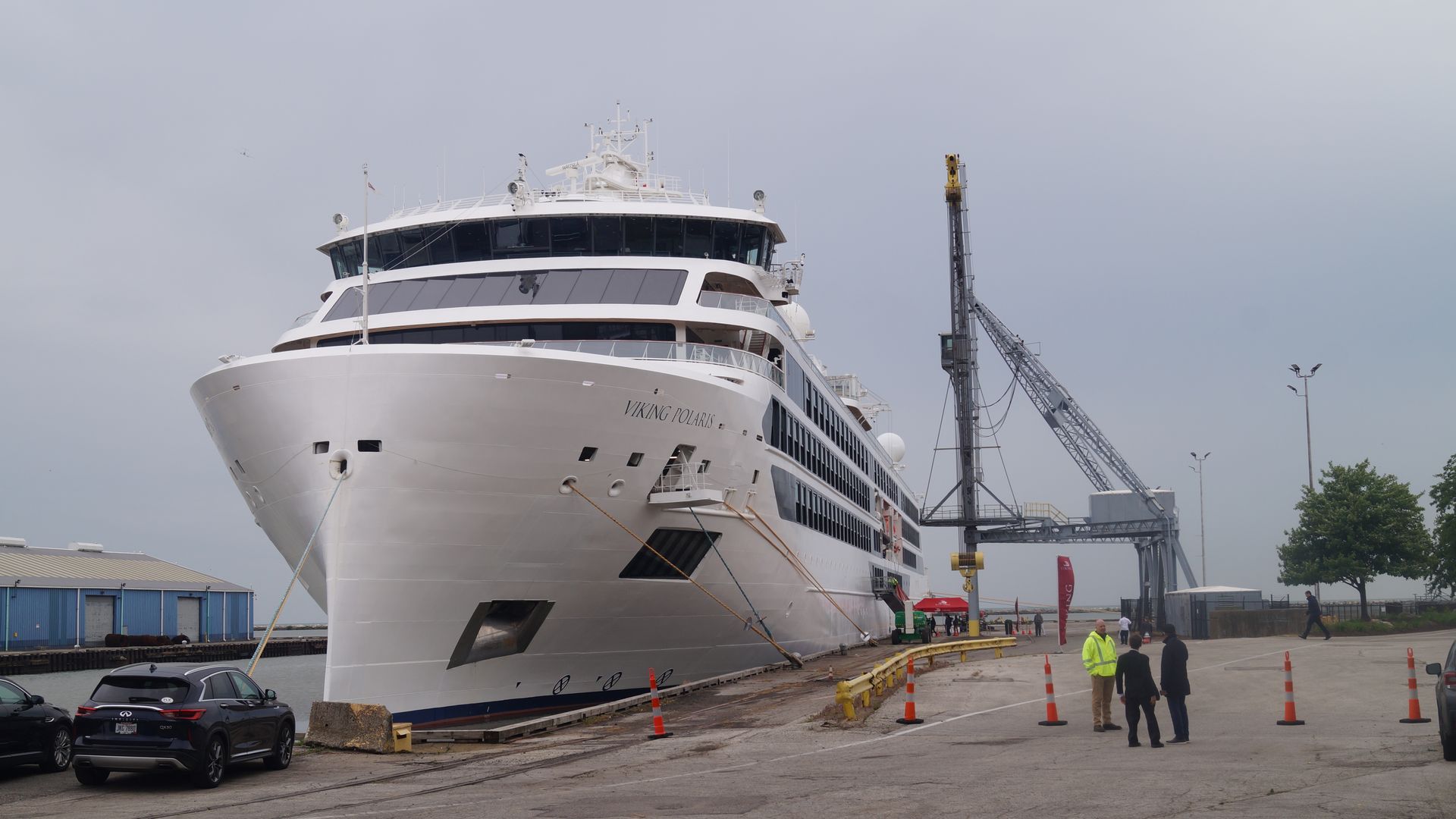 A white Viking cruise ship docked at the Cleveland harbor, with overcast sky