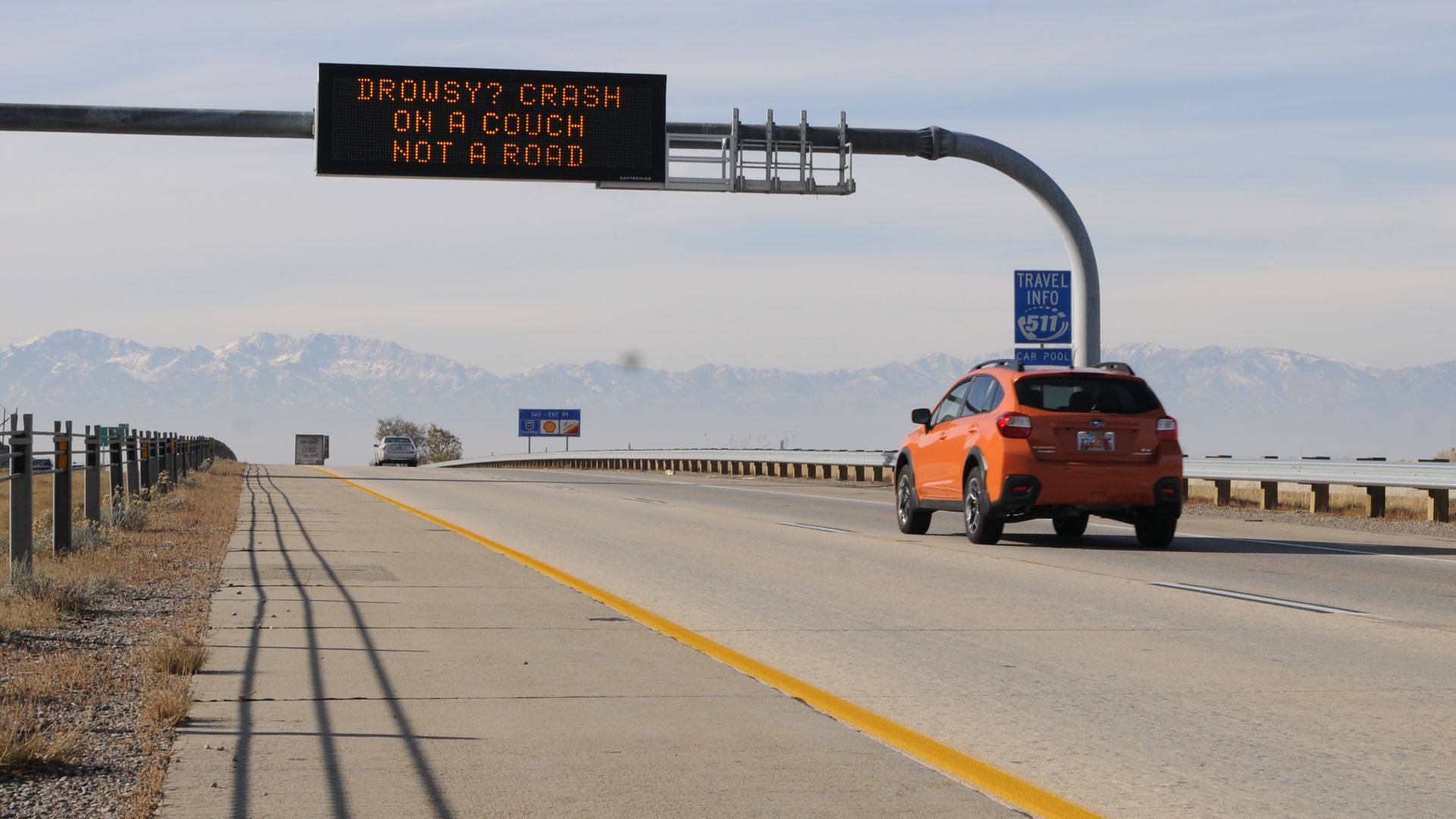 A digital sign over a freeway that says: Drowsy? Crash on a couch not a road.