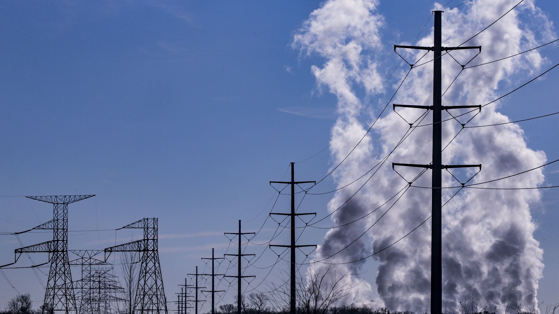 Smoke billows near power lines