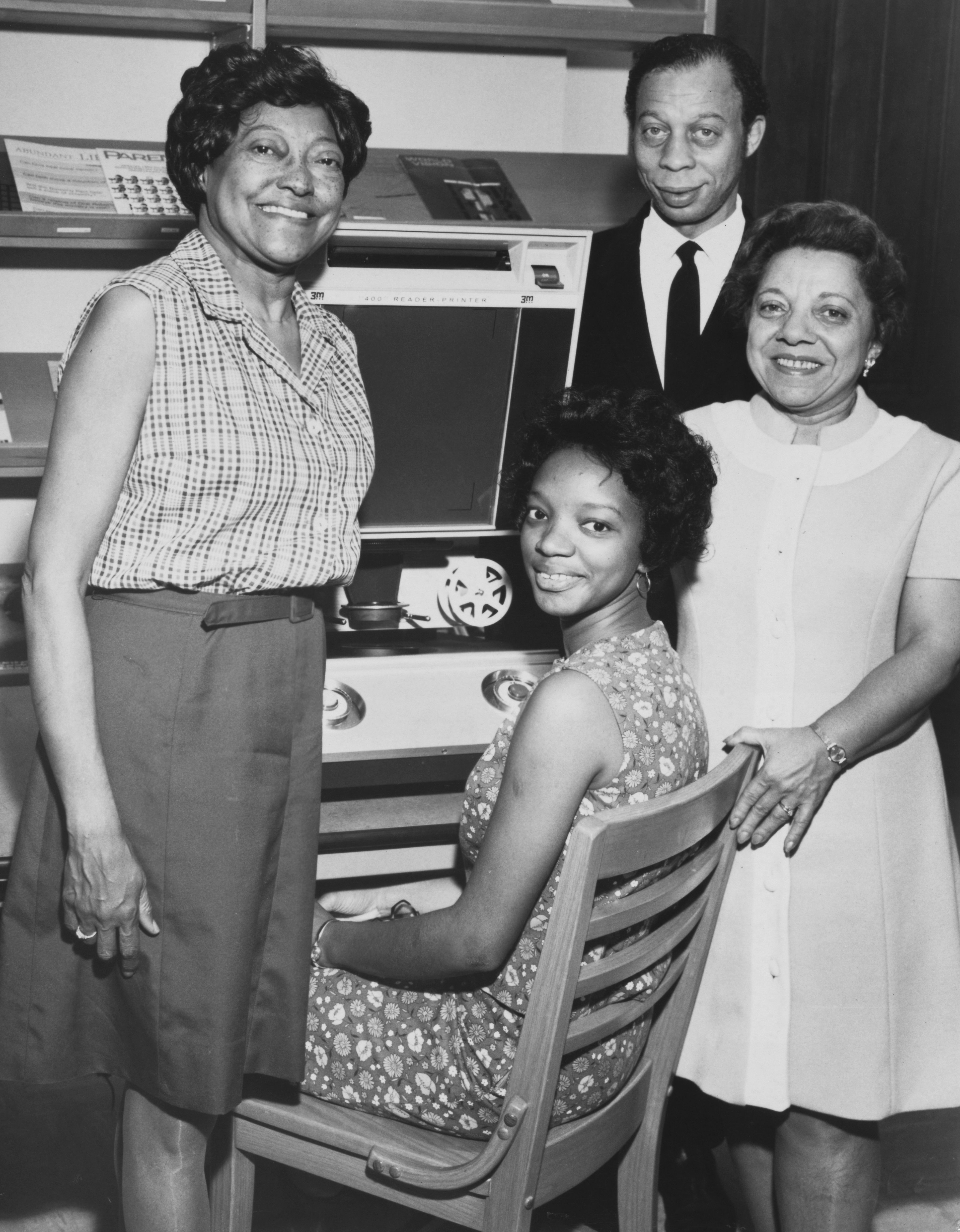 A student (seated) using a reader-printer for the first time at Atlanta University, US, circa 1965; with her (L-R) Mexico Mickelbury, librarian at Spelman College, Richard A Long, professor of English at Atlanta University and director of the university's Conference on African and African-American Studies (CAAS) and Virginia Lacy Jones, Dean at the School of Library Science at Atlanta University. (Photo by Authenticated News/Archive Photos/Getty Images)
