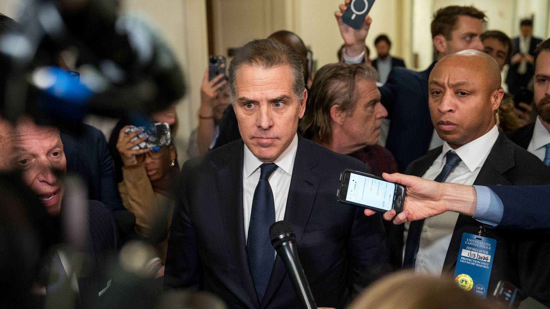 Hunter Biden is surrounded by microphones and recorders in Congressional halls
