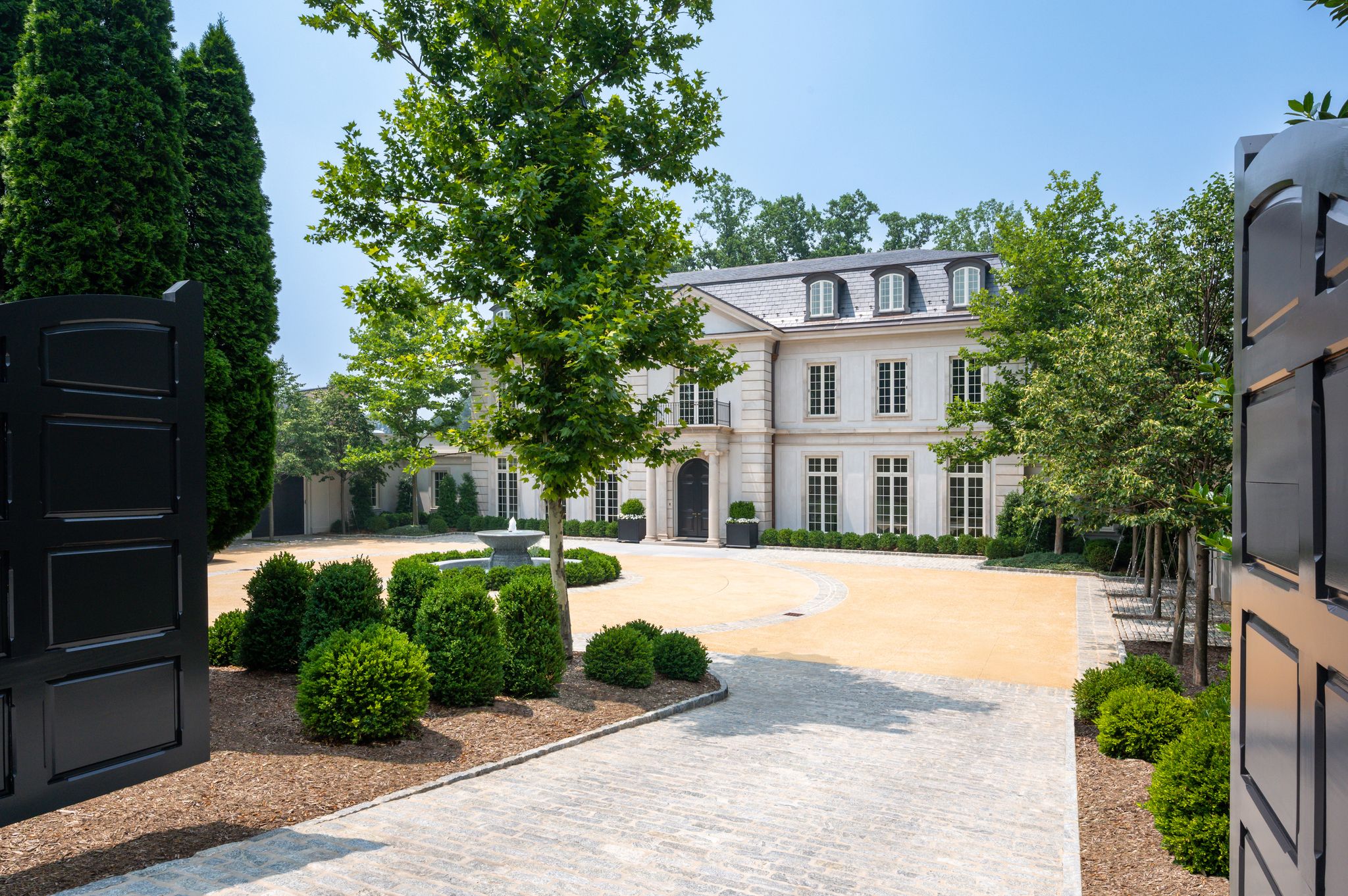 A photo of a large home in Washington, D.C., with a fountain in front.