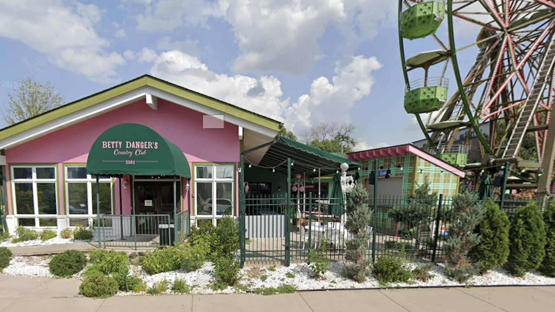 A photo of the front of Betty Danger's next to a ferris wheel 