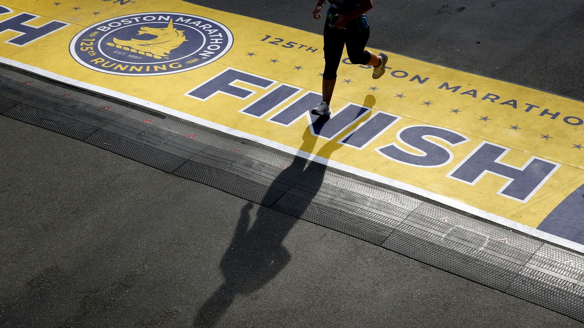 A runner finishing the 125th Boston Marathon