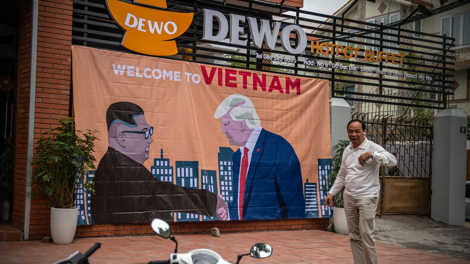 A banner showing President Donald Trump and North Korean leader Kim Jong-un shaking hands next to the words 'Welcome to Vietnam' 