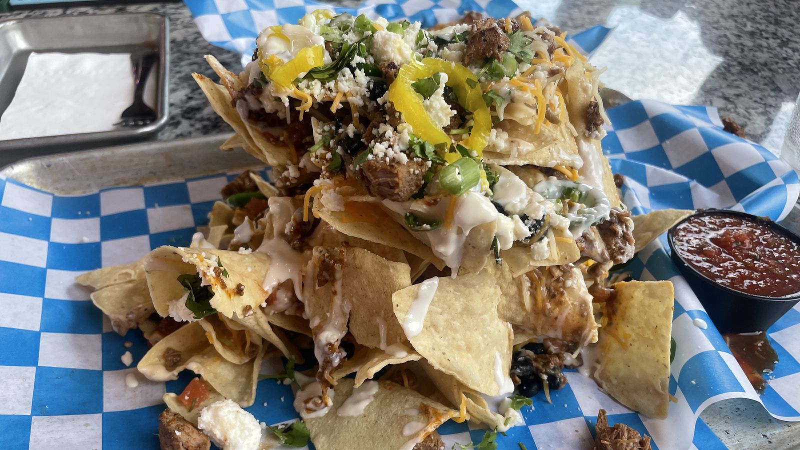 Eat a "gallon of nachos" at The Pelican Post Bar & Grille in Des Moines