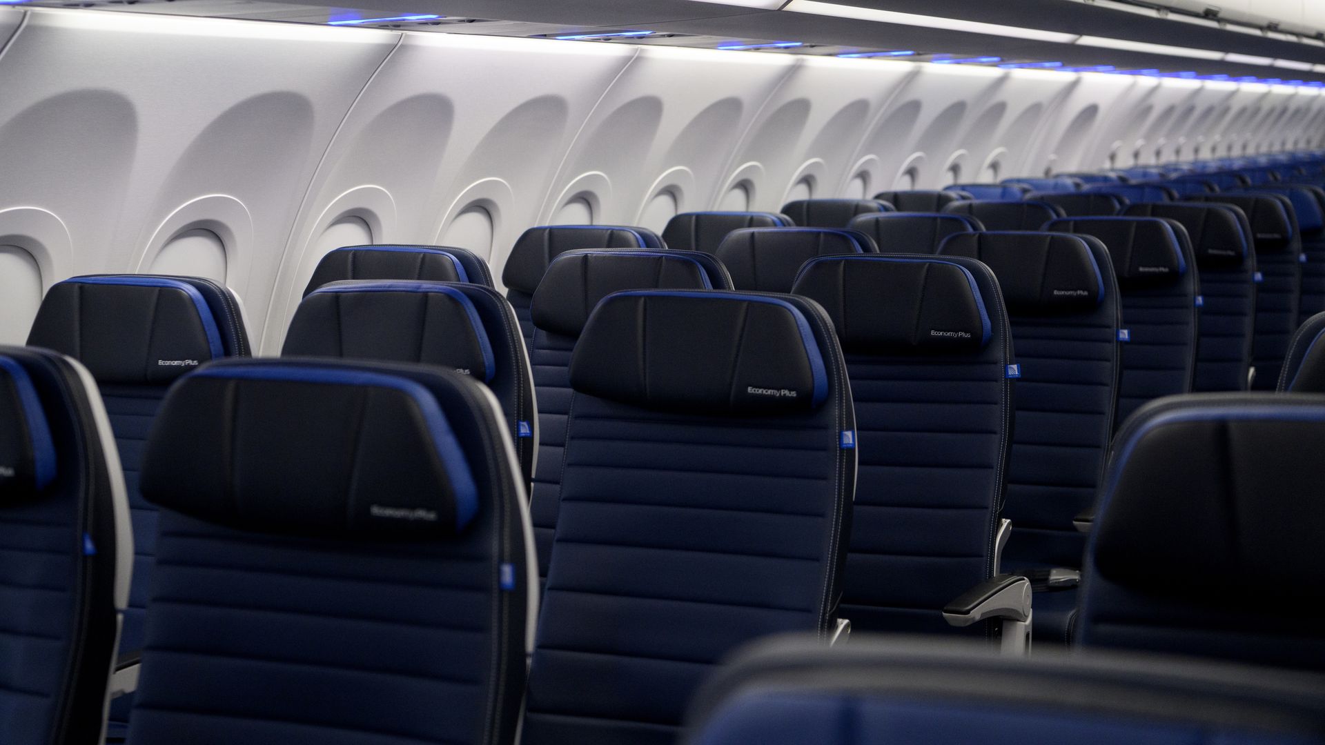 Rows of empty seats on a plane.