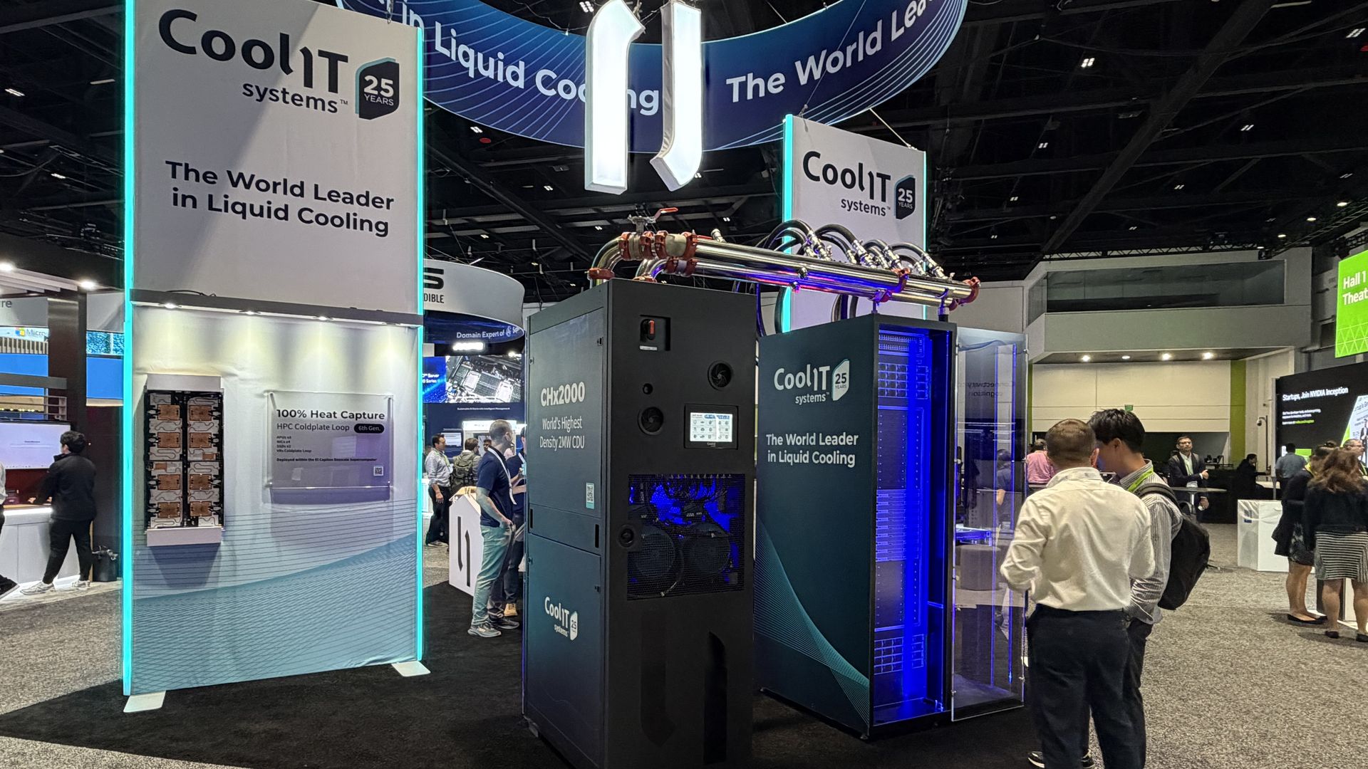 Trade show booth for CoolIT Systems promoting liquid cooling. Large white panel reads "The World Leader in Liquid Cooling", blue-lit cabinet, and visitors inspect equipment under a curved banner.