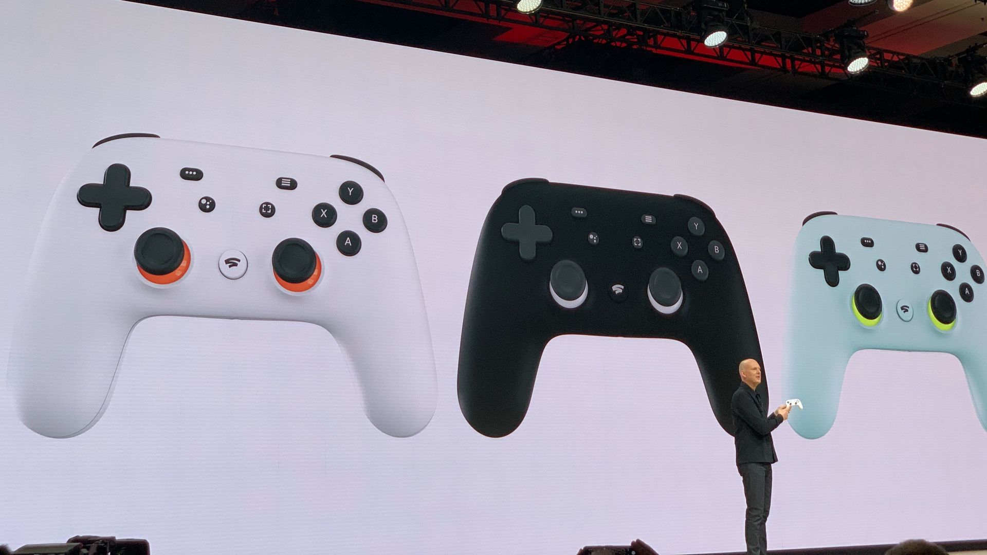 Google executive standing before projection of Google's new Stadia game controller