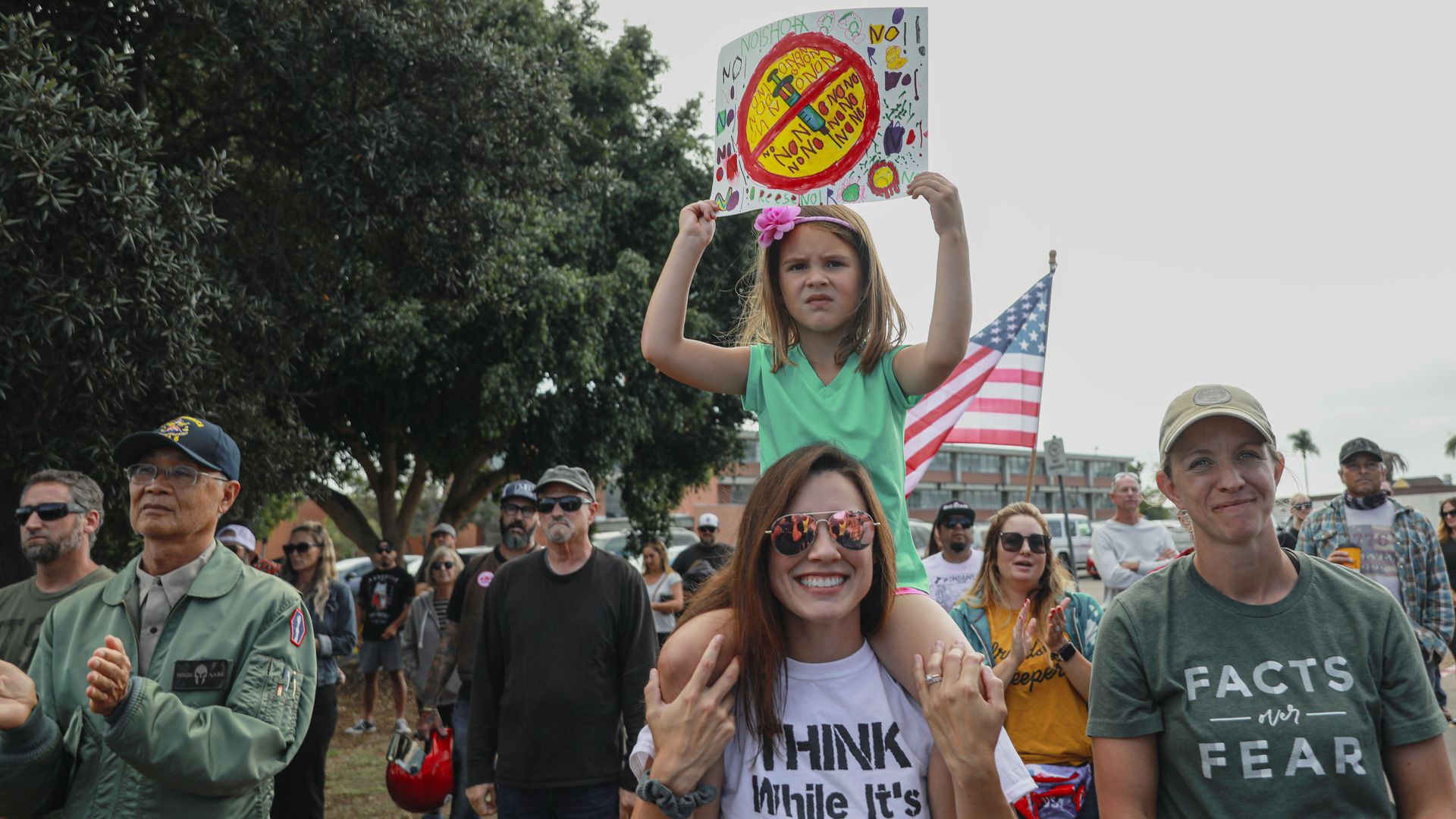 Anti-vaccine protesters stage a protest outside of the San Diego Unified School District office to protest a forced vaccination mandate for students
