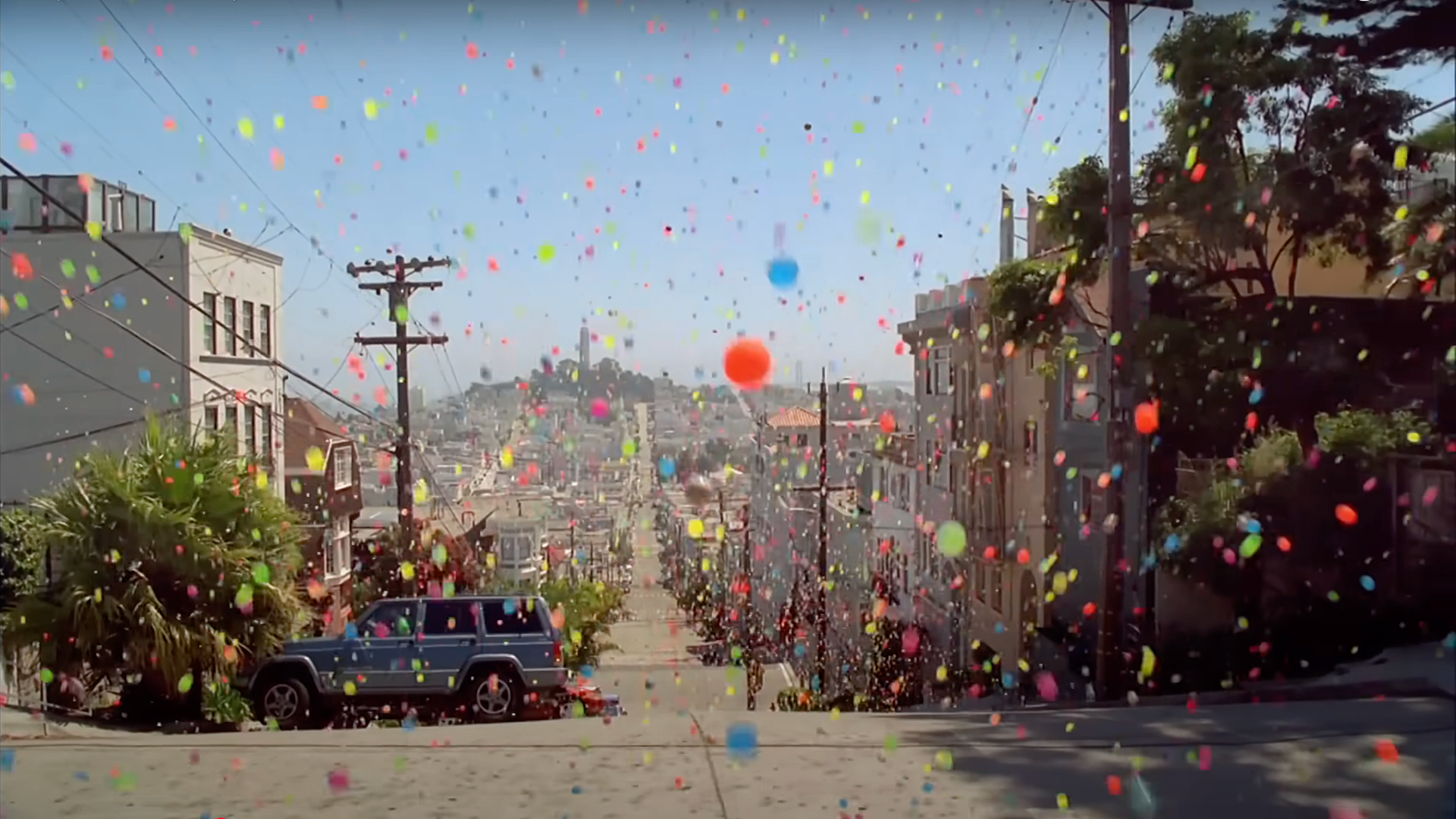 Photo of hundreds of colorful bouncy balls bouncing down a San Francisco street