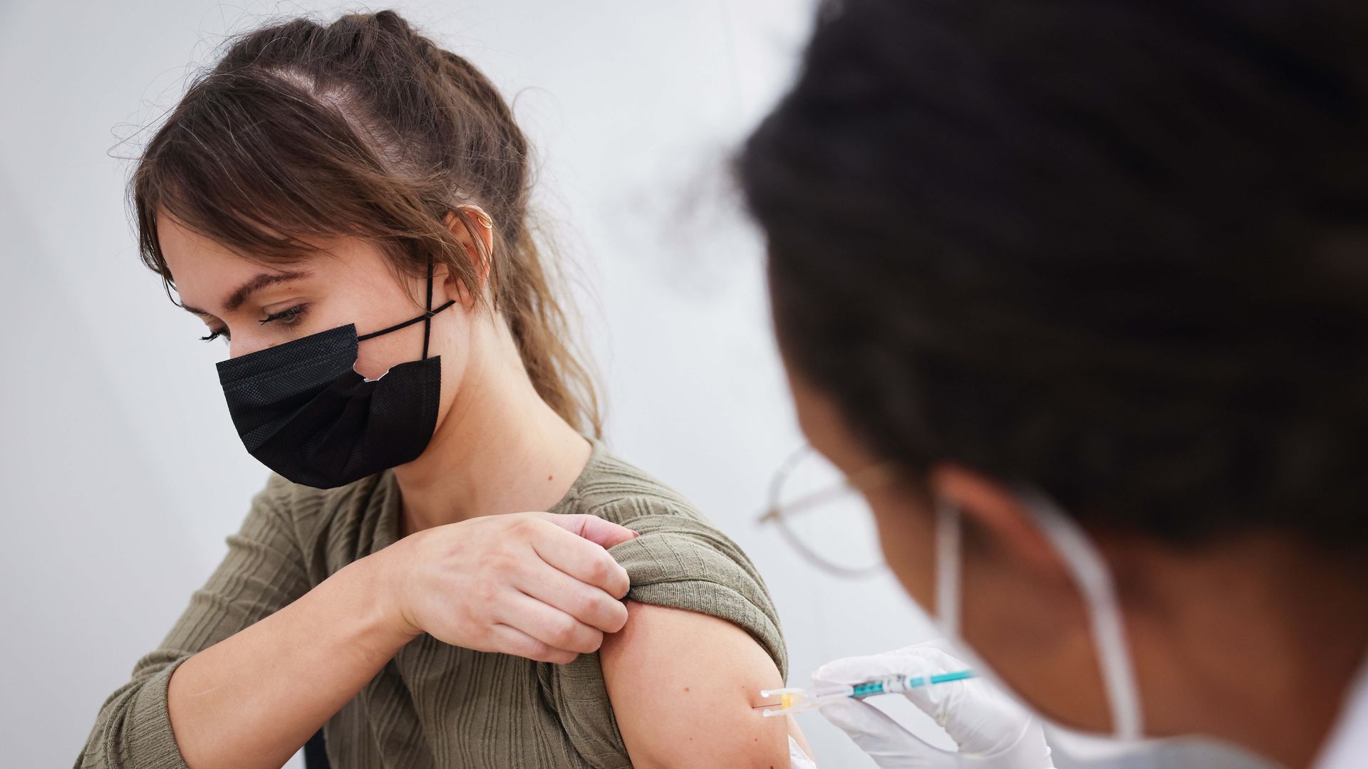 A woman receives her second vaccination with the Biontech/Pfizer vaccine at the Hamburg Vaccination Center