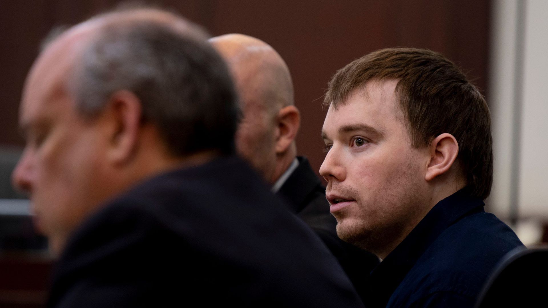 Travis Reinking sits in court during the first day of his murder trial.