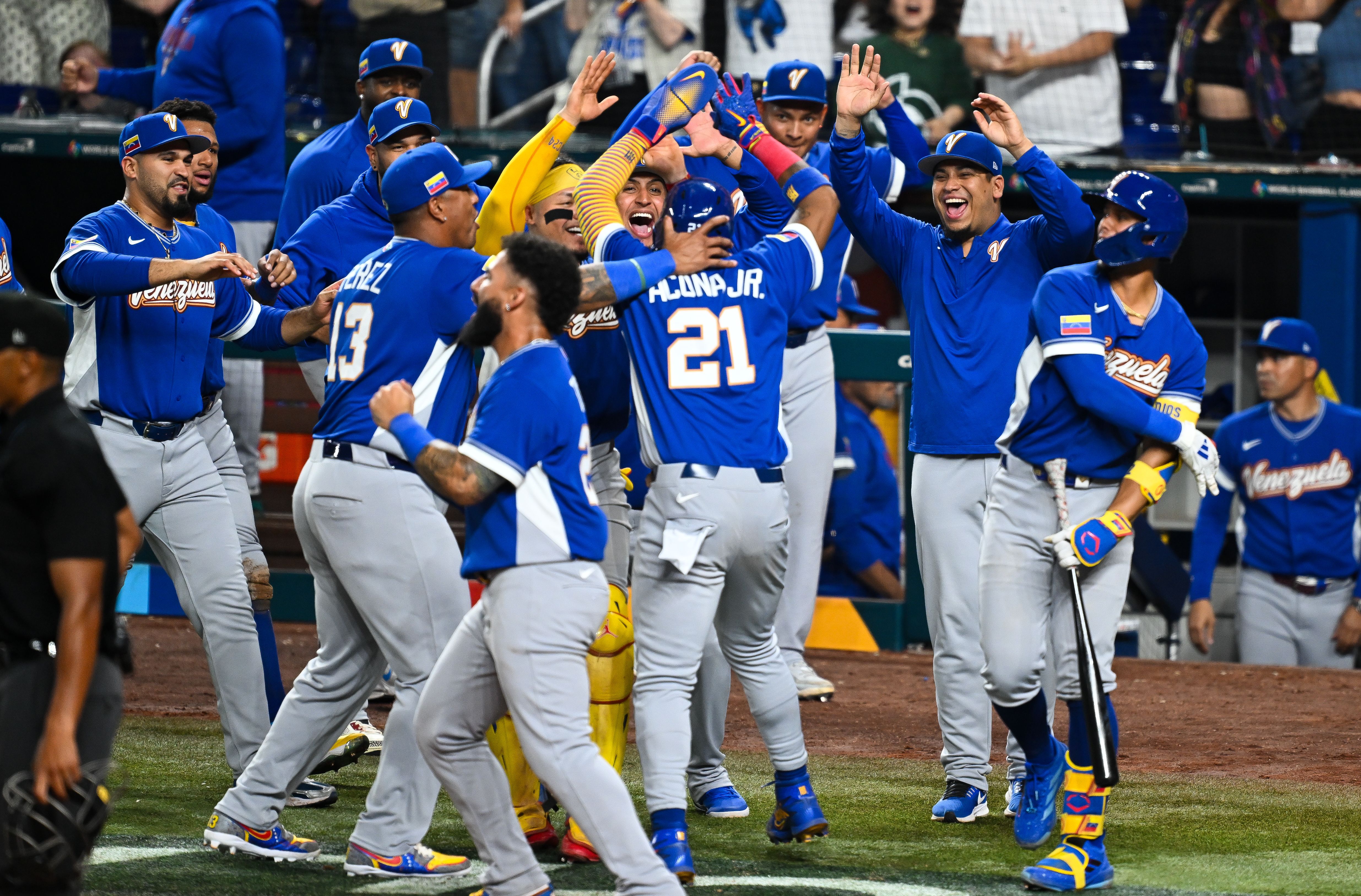 Ronald Acuña Jr. #21 of Team Venezuela celebrates with teammates after scoring in the seventh inning during the 2026 World Baseball Classic Semifinals between Italy and Venezuela at loanDepot park on March 16, 2026 in Miami, Florida. (Photo by Gene Wang - Capture At Media/Getty Images)