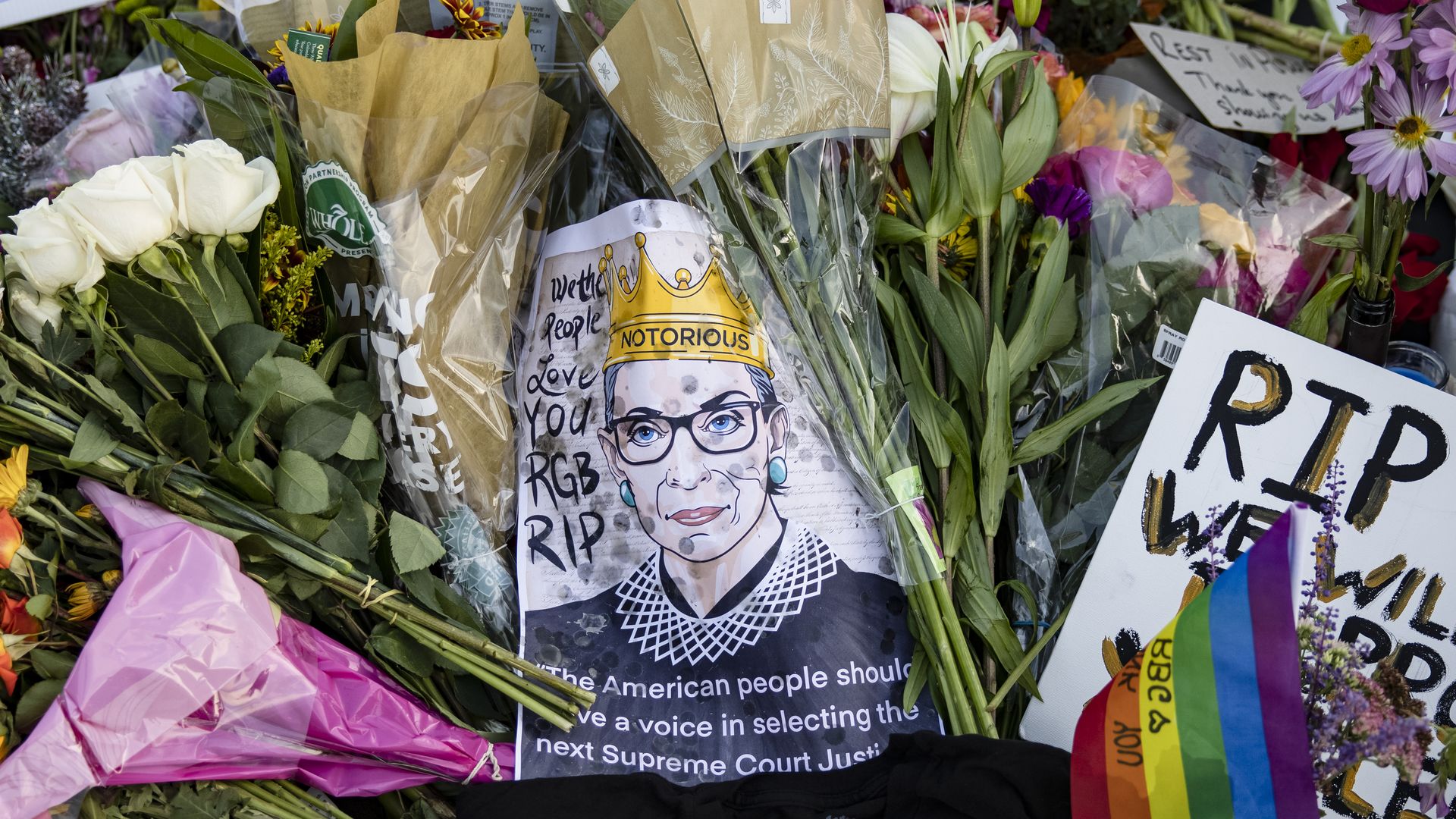 Mourners place flowers, messages, and mementos at a makeshift memorial in honor of Supreme Court Justice Ruth Bader Ginsburg in front of the US Supreme Court