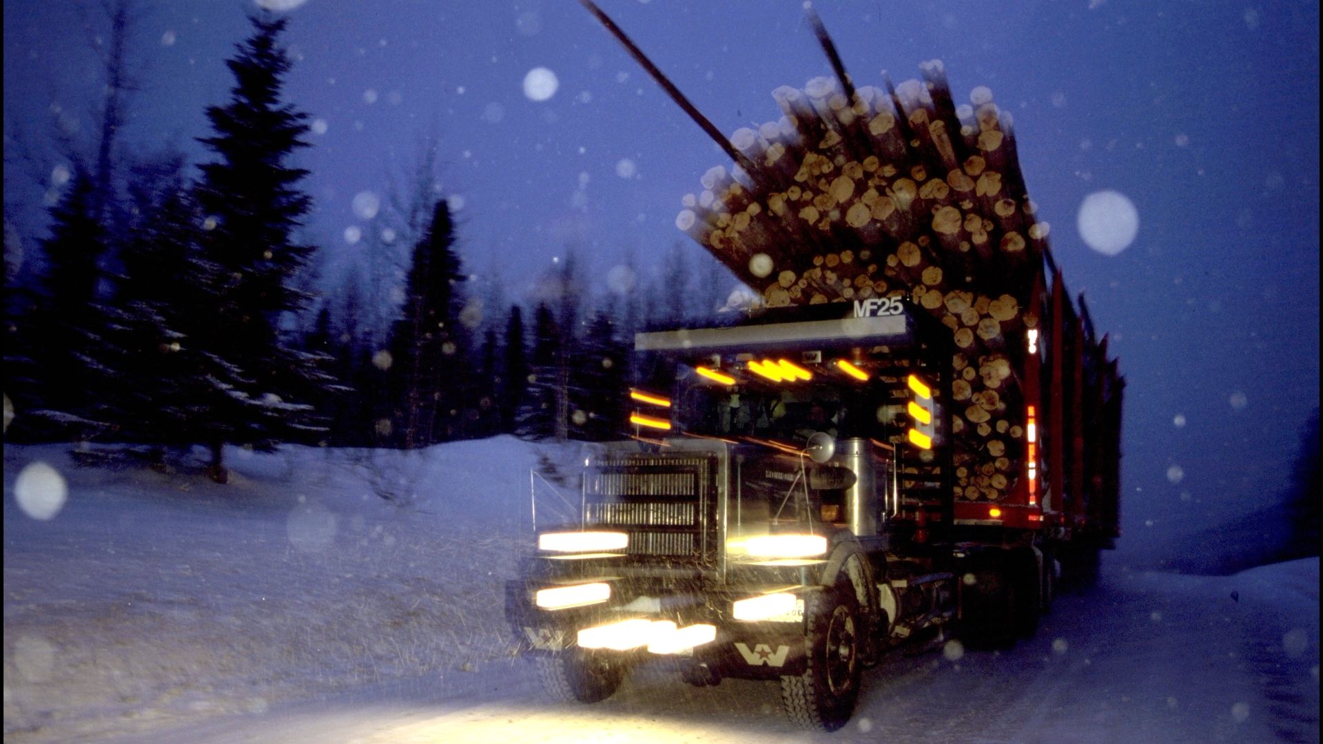 Truck carrying lumber in the snow