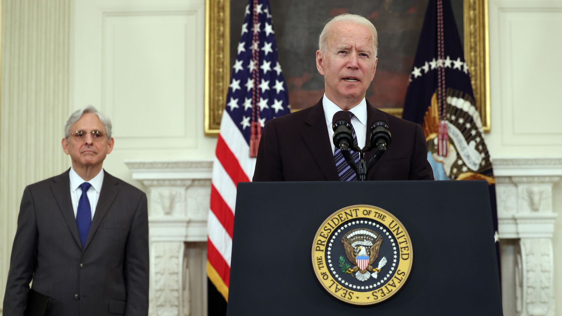 President Joe Biden speaks on gun crime prevention measures as Attorney General Merrick Garland looks on.