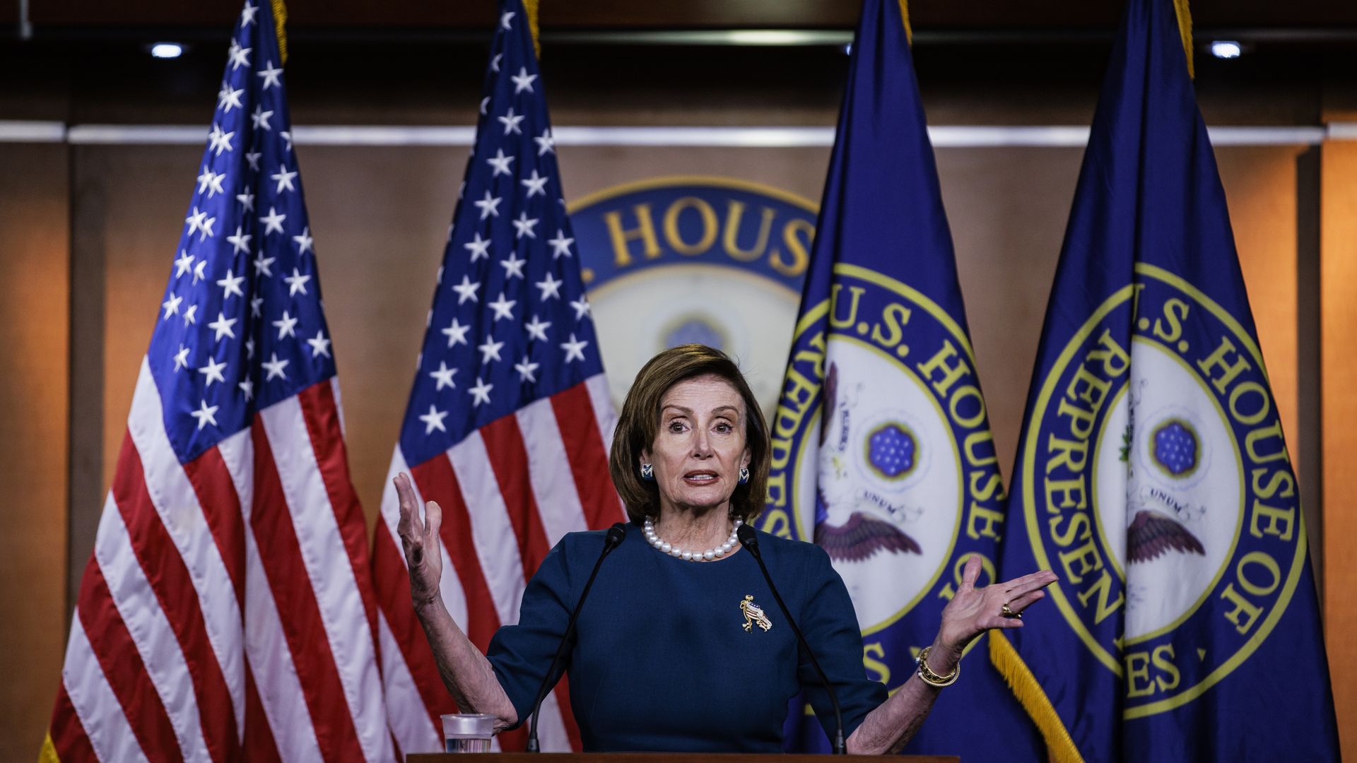 Pelosi speaks behind lectern