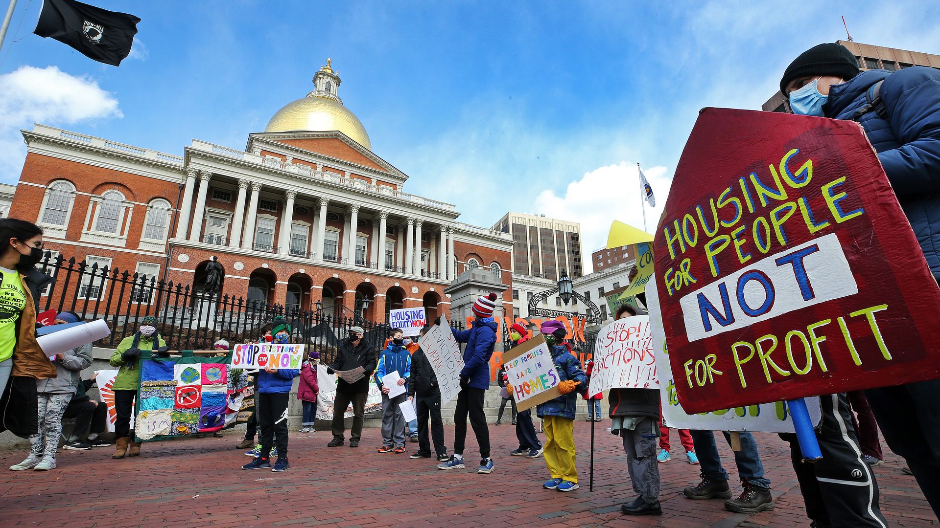 People and students from Worker's Circle of Boston and members of City Life Vida Urbana protest to rally.
